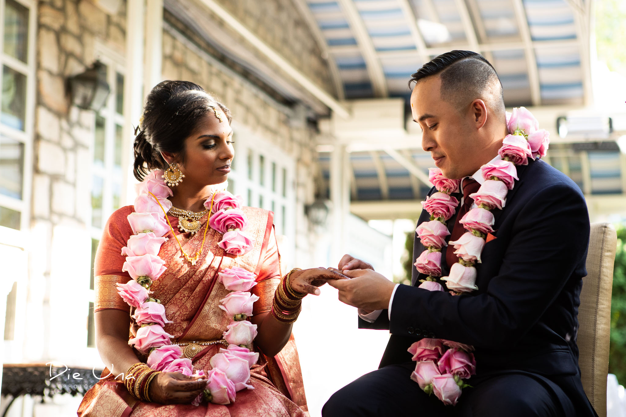 bride and groom exchange wedding rings in Auberge du Pommier terrace in Toronto.jpg