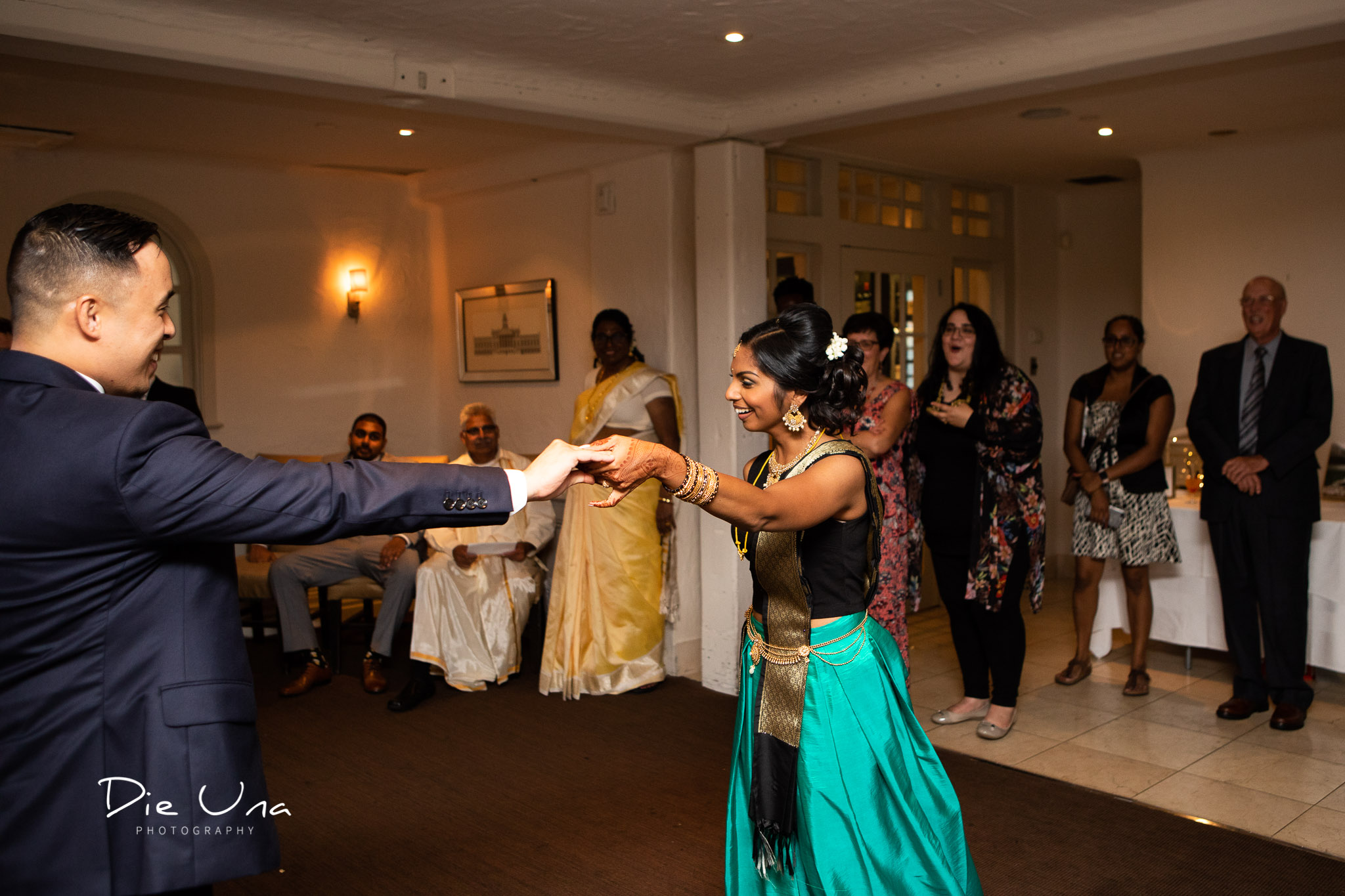 bride and groom first dance while groom uses chair to support his broken leg.jpg