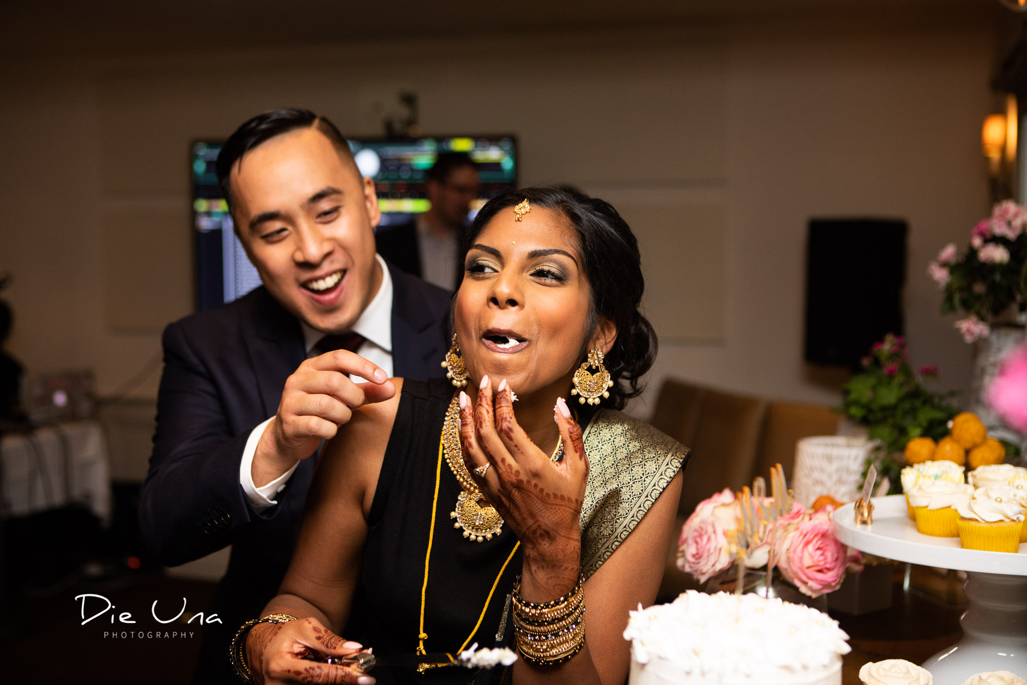 bride eating the cake before groom and laughing.jpg
