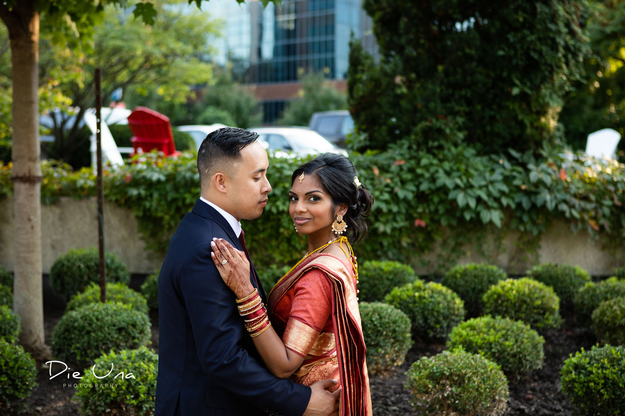 bride looking at camera and groom looking bride with greenery in the background at the Auberge du Pommier in Toronto.jpg