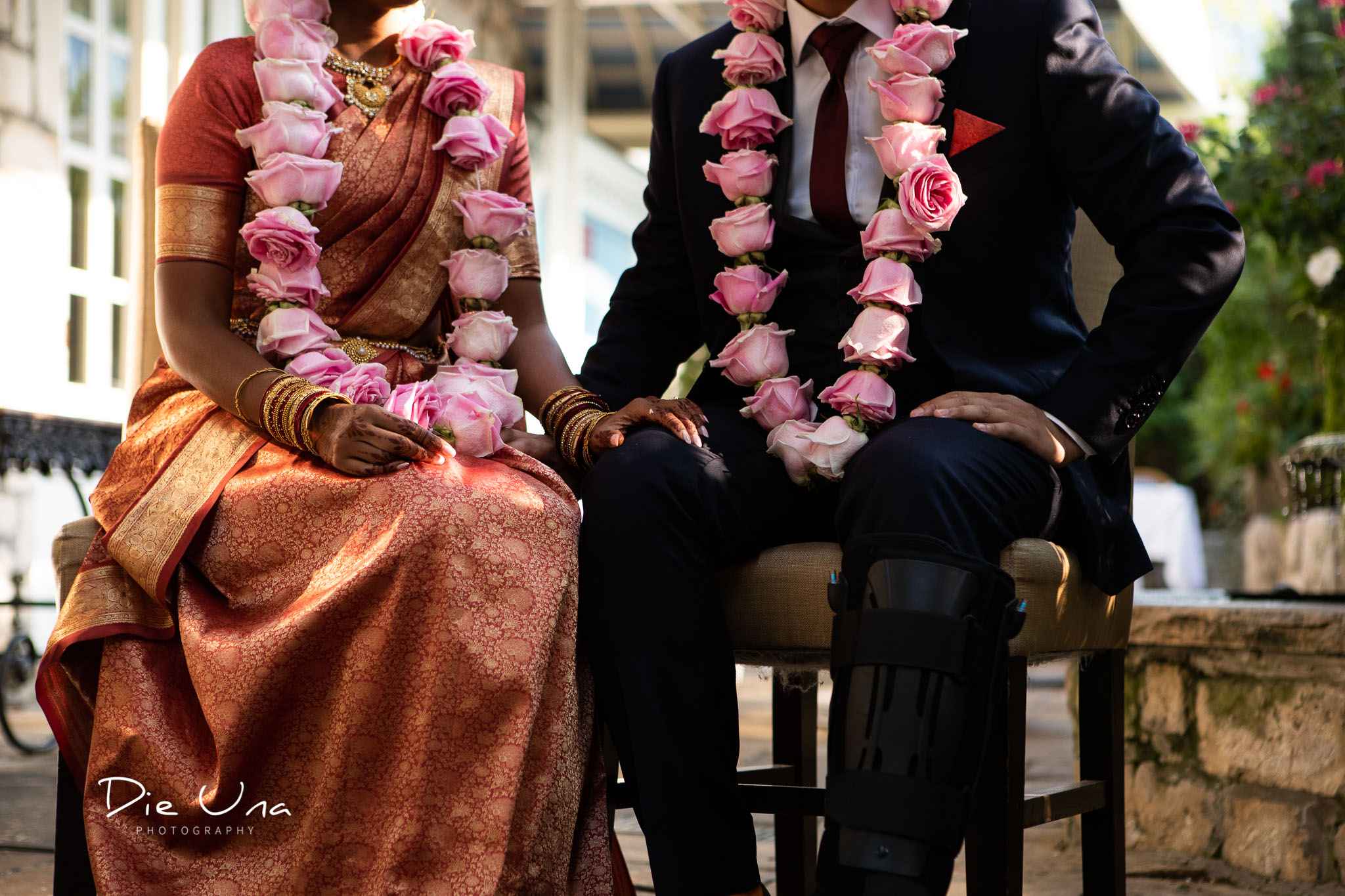 bride wearing saree and rose garland with groom during wedding ceremony.jpg