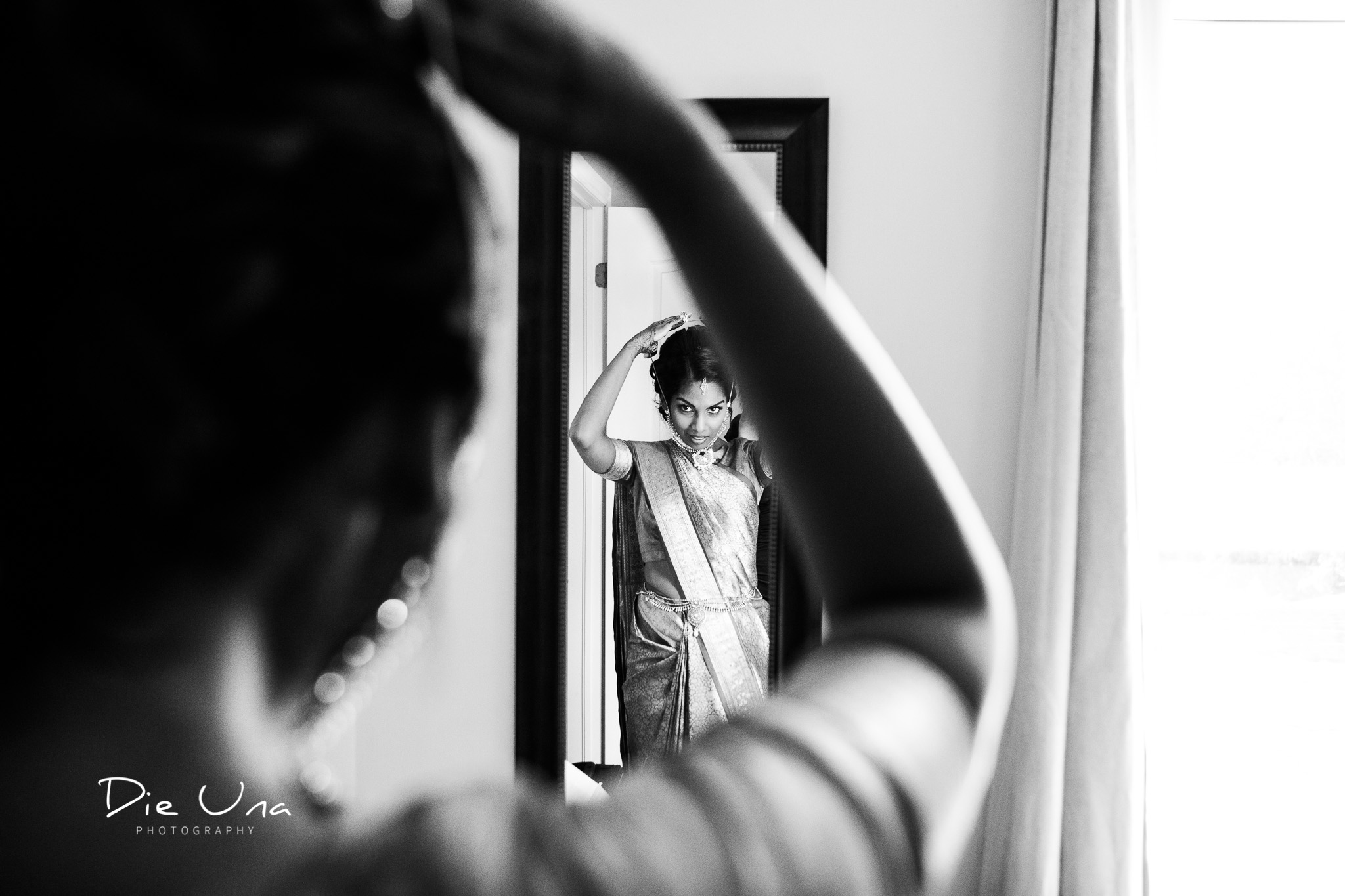 bride wearing saree getting ready for wedding reflected in mirror.jpg