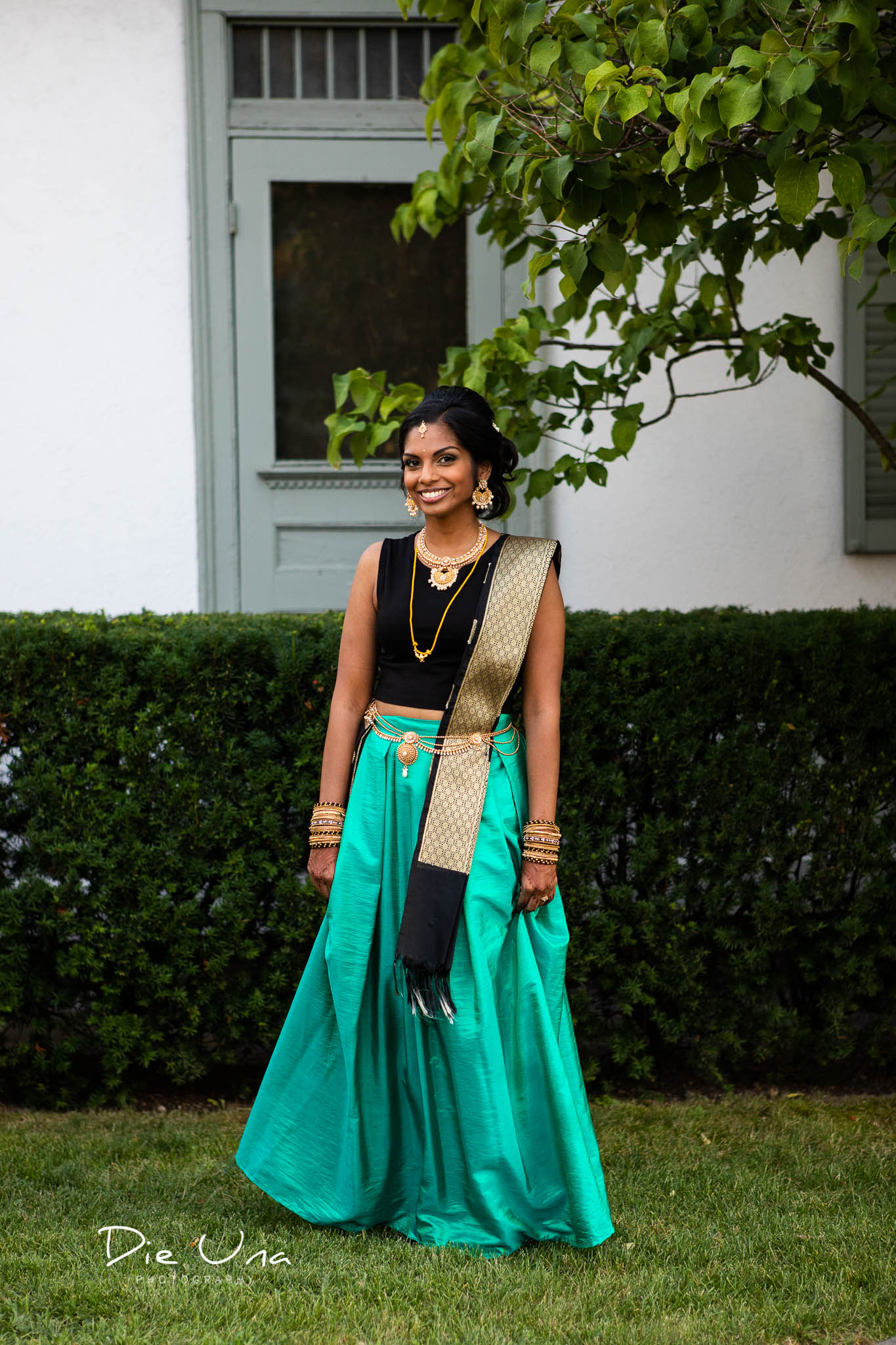 bride wearing second evening outfit with turquoise skirt and black top wearing thaali.jpg