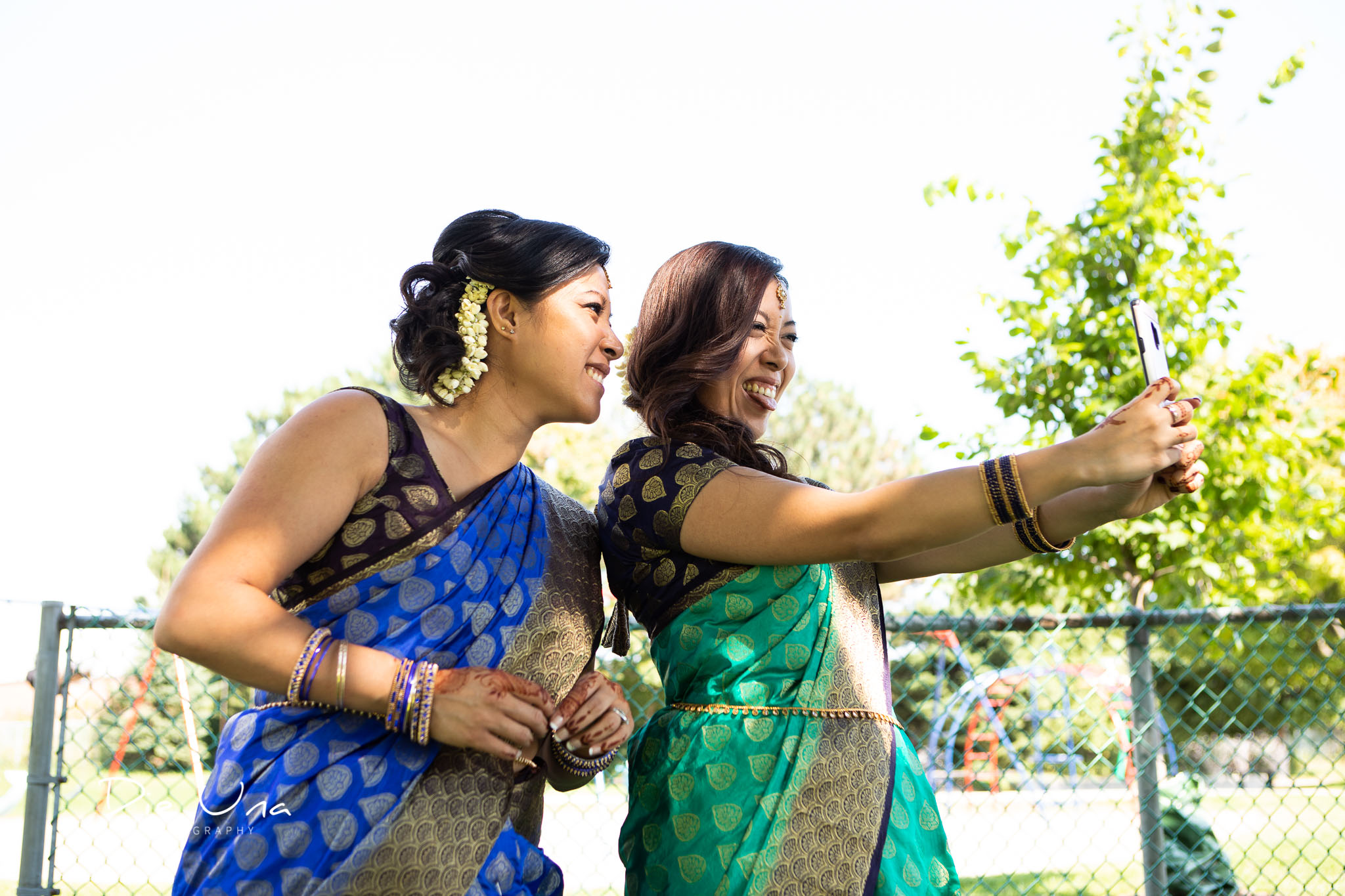 Bridesmaids taking selfies while wearing sarees.jpg