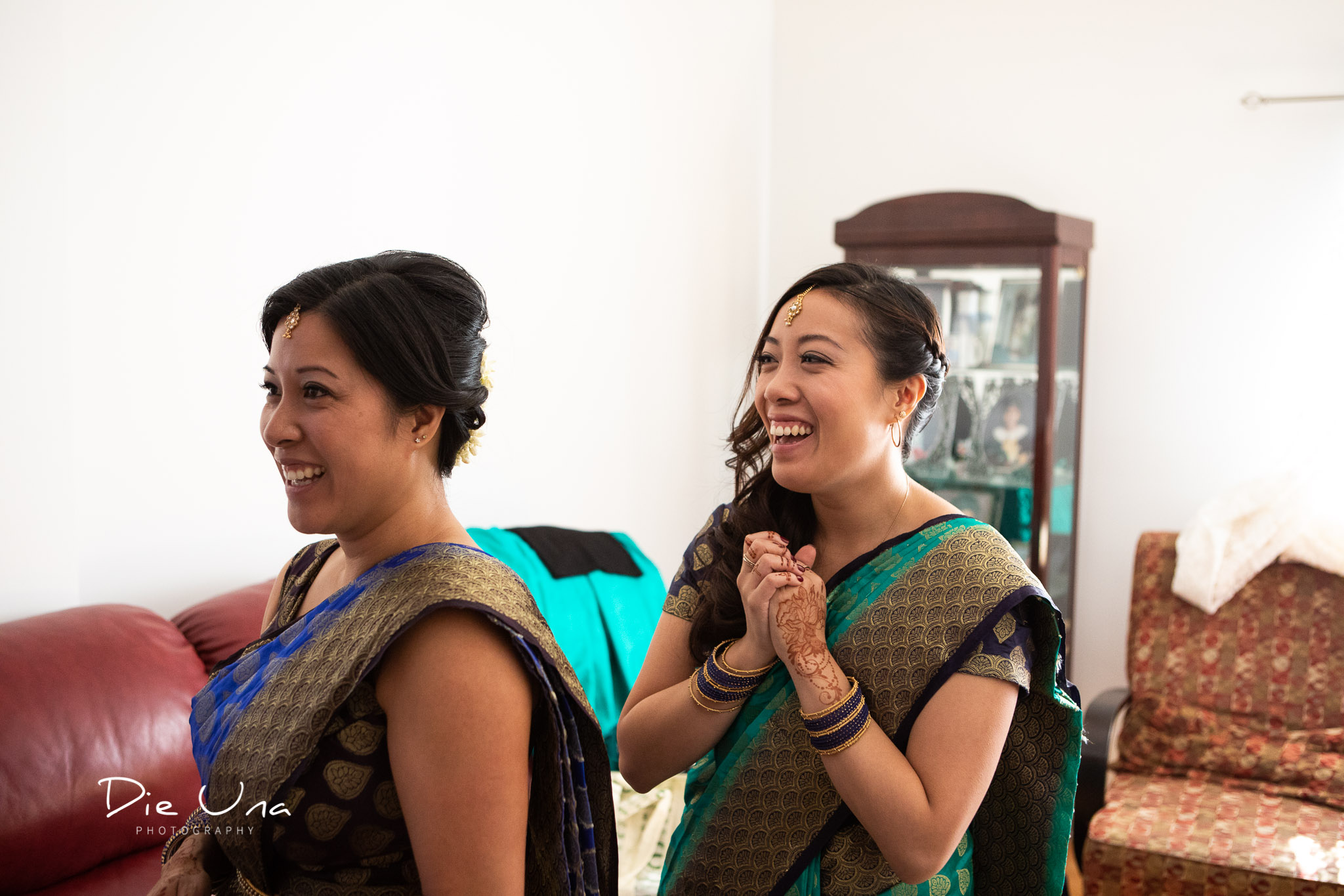 bridesmaids wearing sarees reacting to seeing the bride.jpg