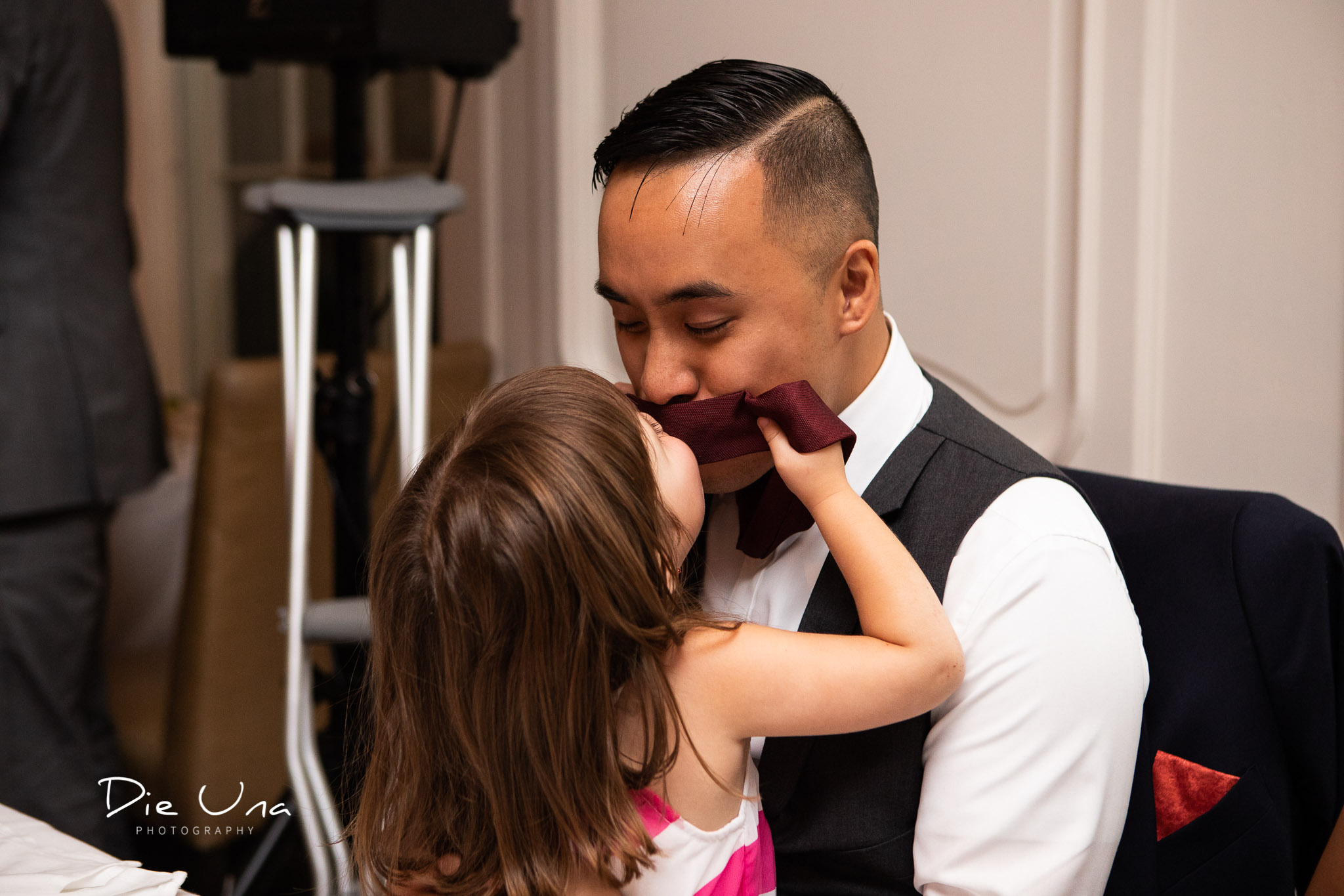 groom and neice being silly and share a kiss through groom's tie.jpg