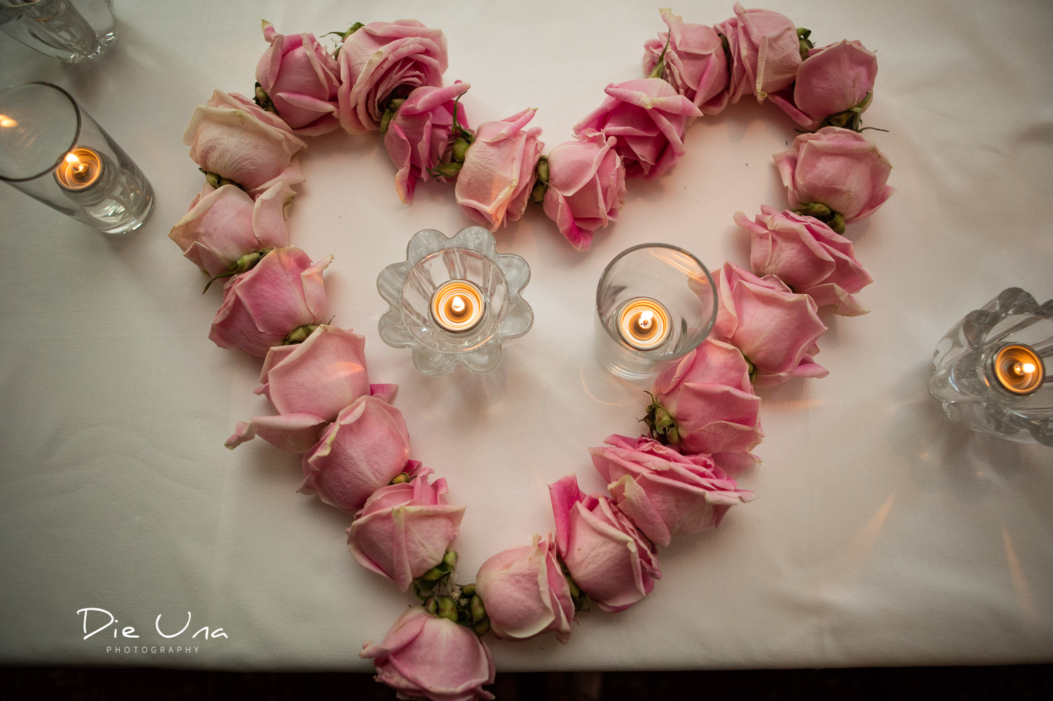 rose garland in the shape of a heart on the head table at wedding reception.jpg