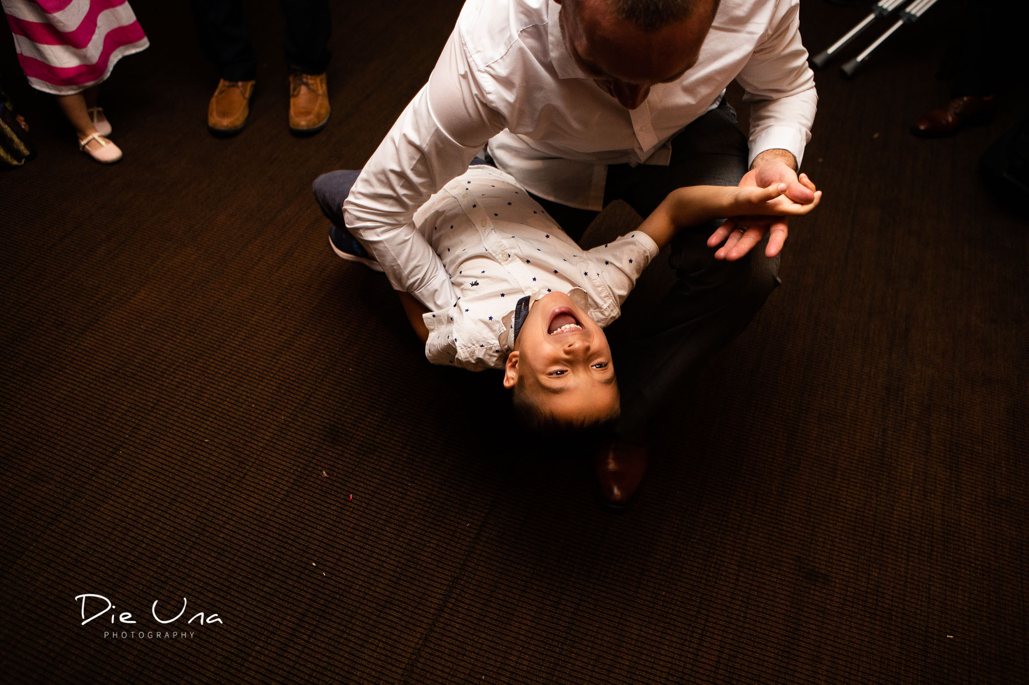 young child dancing with his dad during wedding reception.jpg