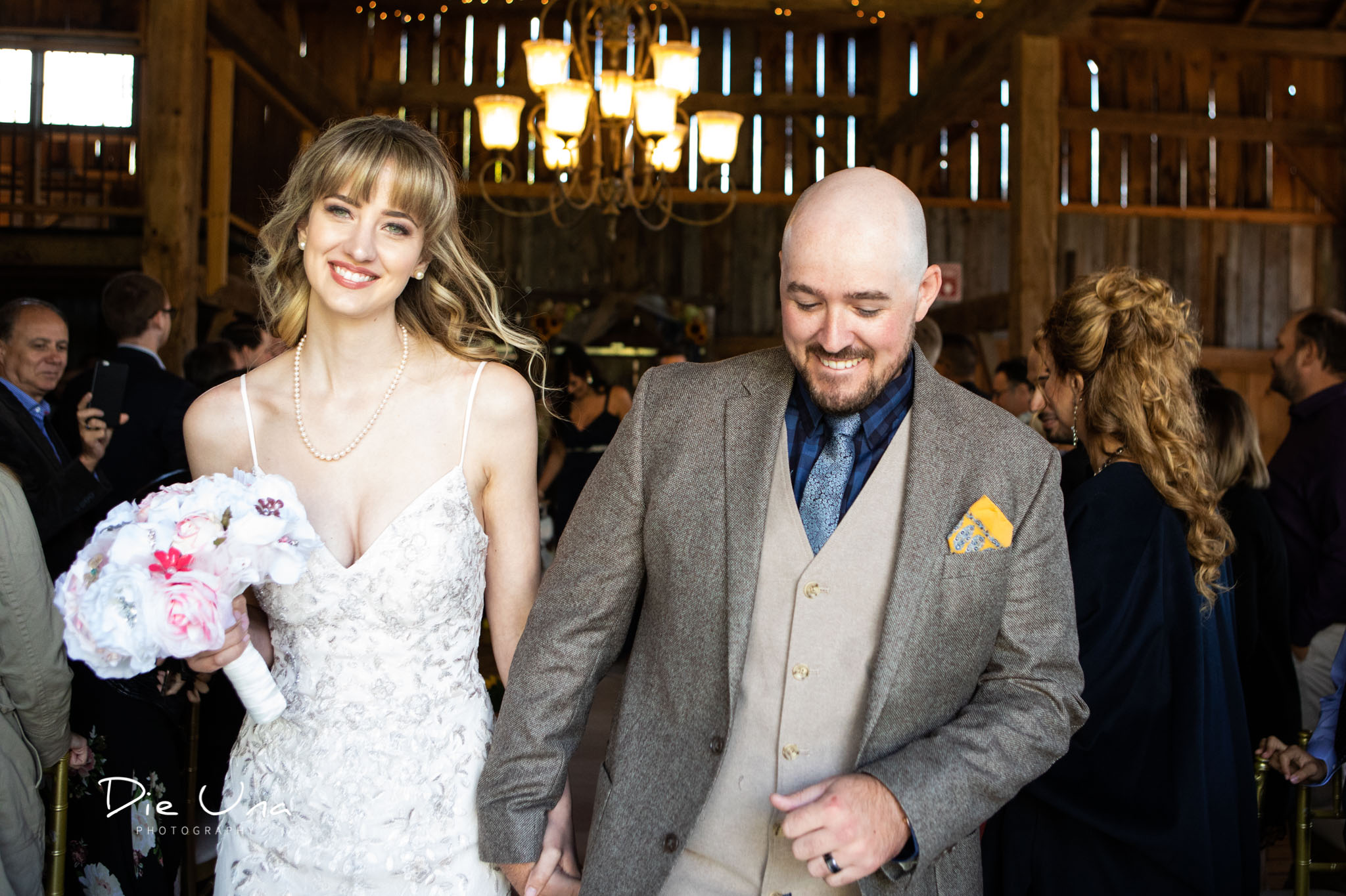 bride and groom newlywed walk down the aisle in barn wedding.jpg