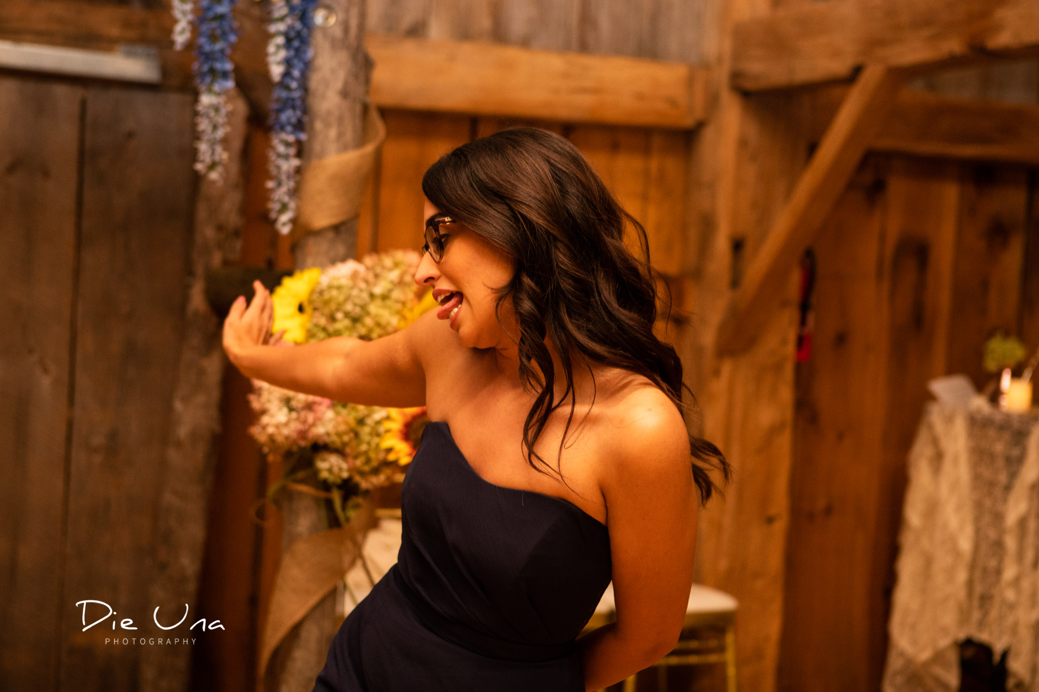 bridesmaid making a silly face during dance at wedding reception in a barn.jpg