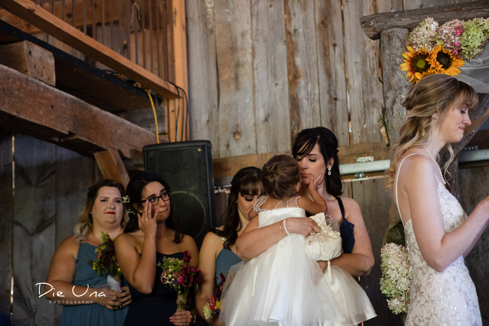 bridesmaids and flower girl crying during wedding ceremony in a barn in southern ontario.jpg