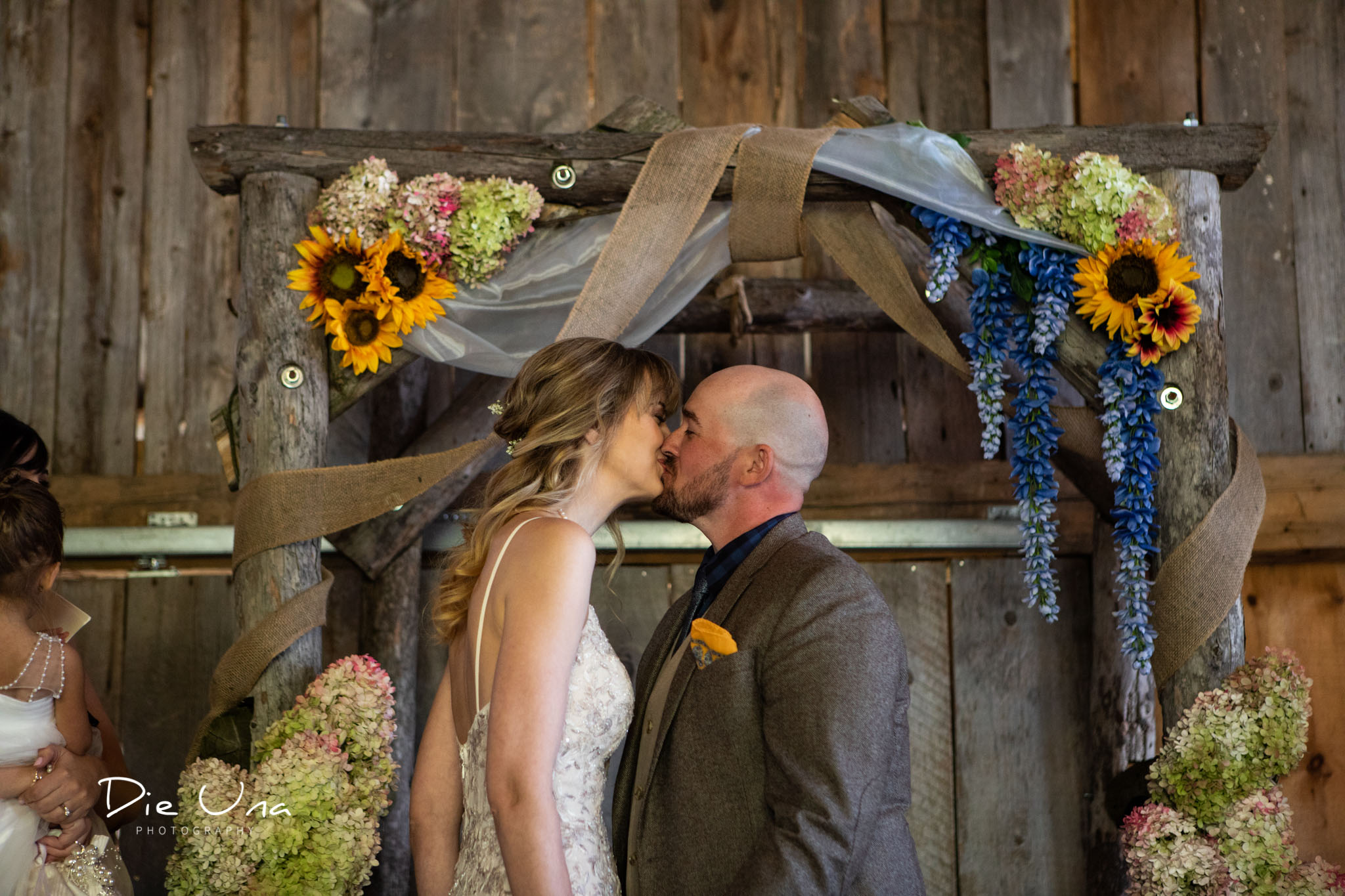 first kiss during barn wedding ceremony in southern ontario.jpg