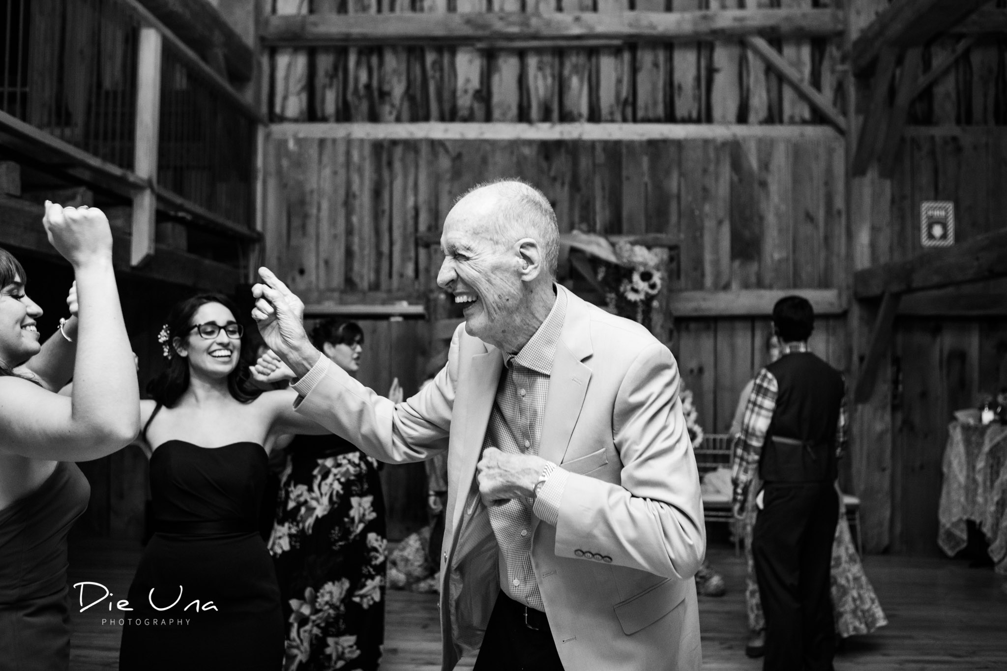 grandfather dancing during dance wedding reception in a barn.jpg