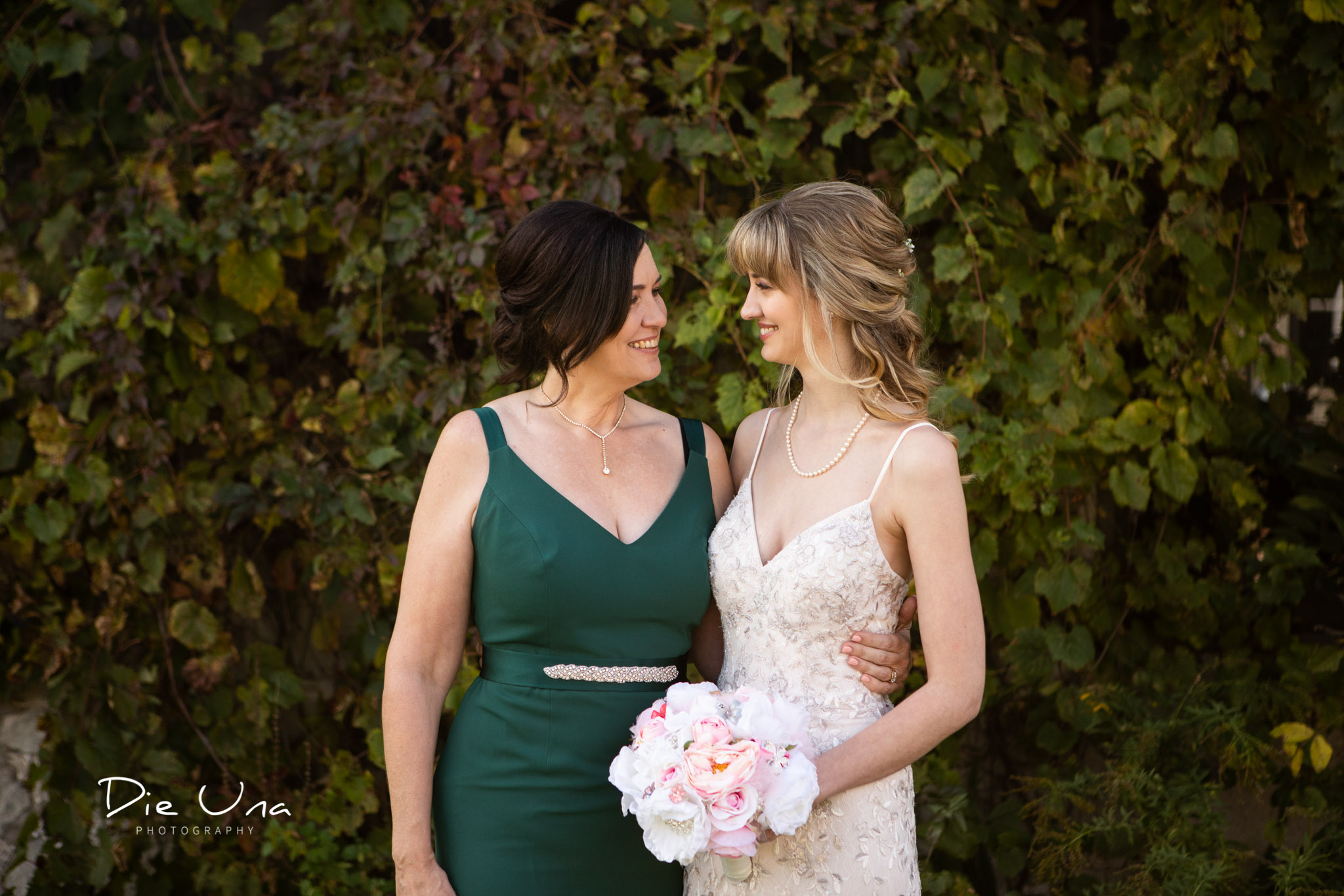 mother and daughter mother of bride and bride look at each other during wedding portraits.jpg