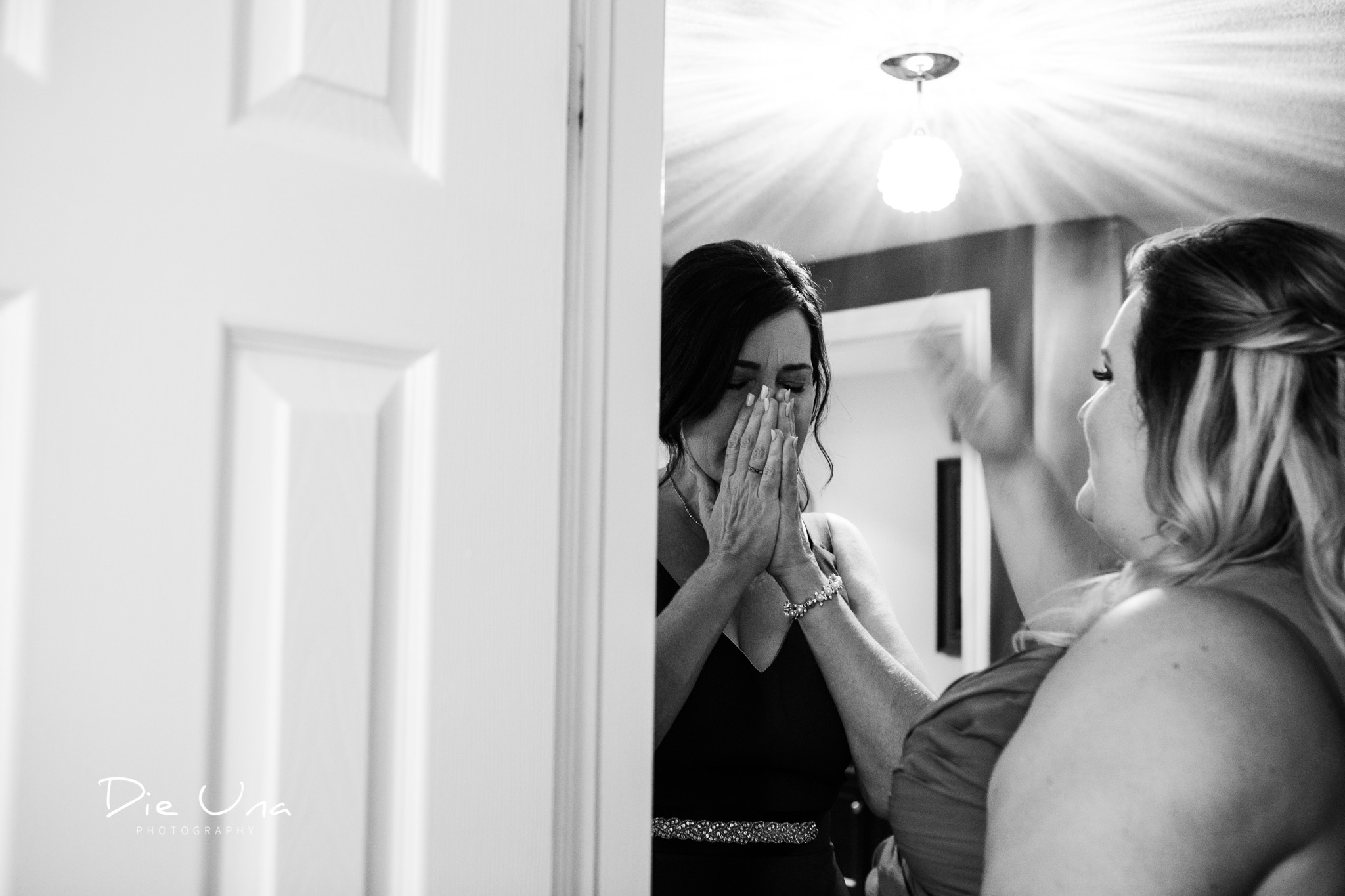 mother of the bride MOB getting emotional at seeing her daughter all dressed in her wedding gown.jpg