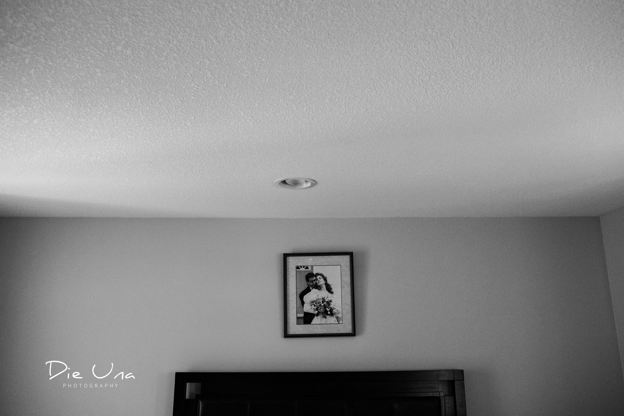 Old wedding portrait hanging in bride getting ready space black and white wedding photography.jpg