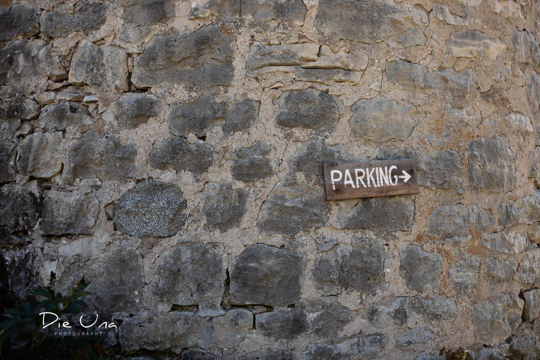 parking sign placed on old brick silo to direct wedding guest where to park.jpg