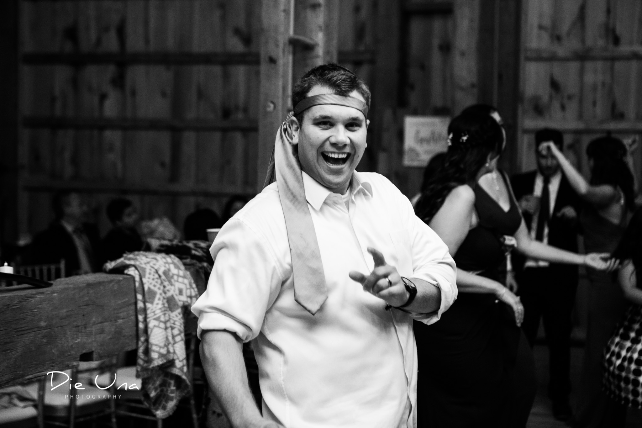 wedding guest wearing tie around his head black and white wedding photography.jpg