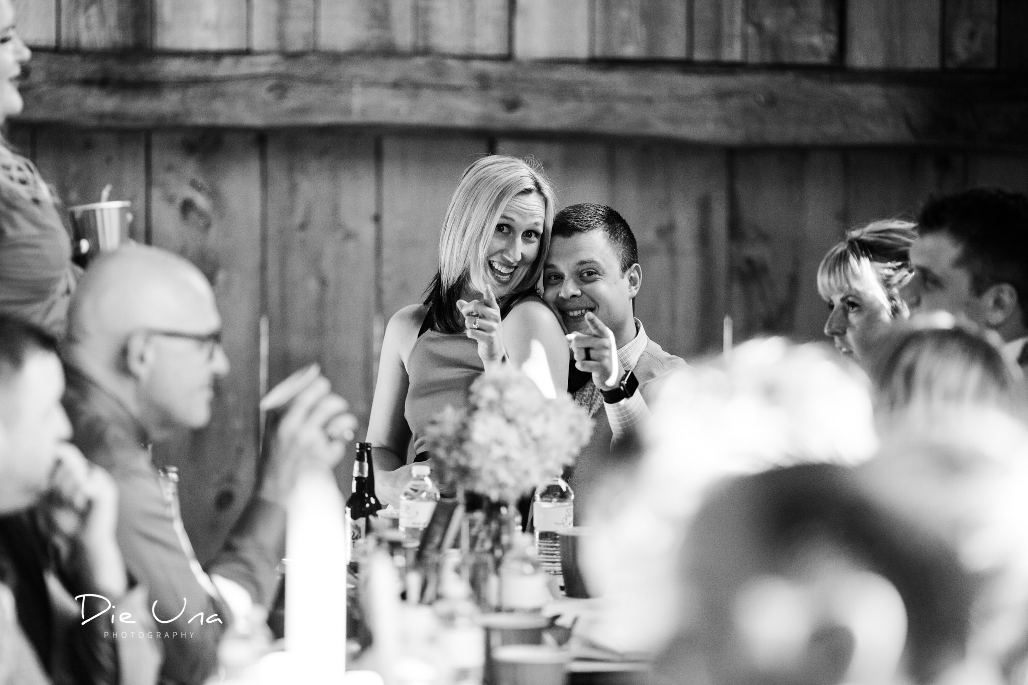 wedding guests being silly during wedding reception black and white candid photography.jpg