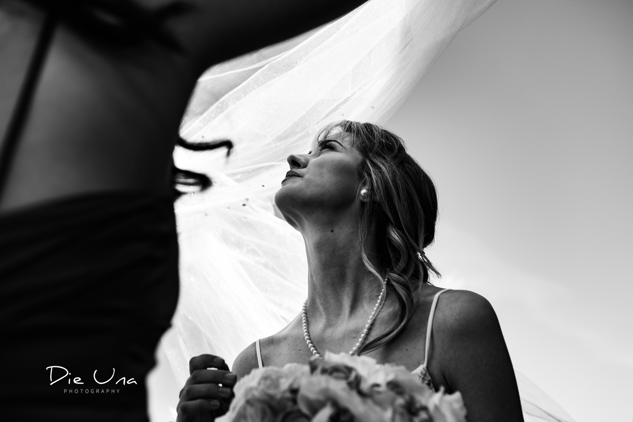 wedding veil getting blown away by wind black and white wedding photography.jpg