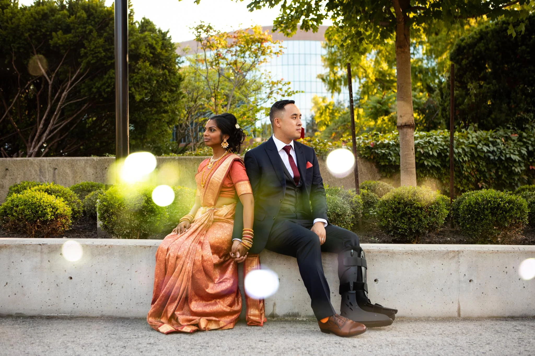 bride and groom sitting on concrete wall in Toronto double exposure photraphy.jpg