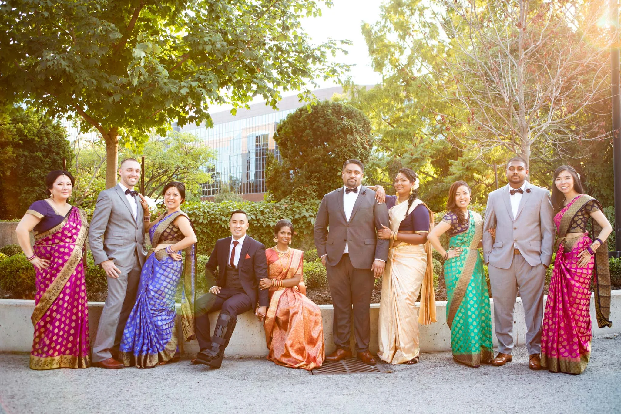 bridesmaids wearing sarees in large wedding party portrait in Toronto.jpg