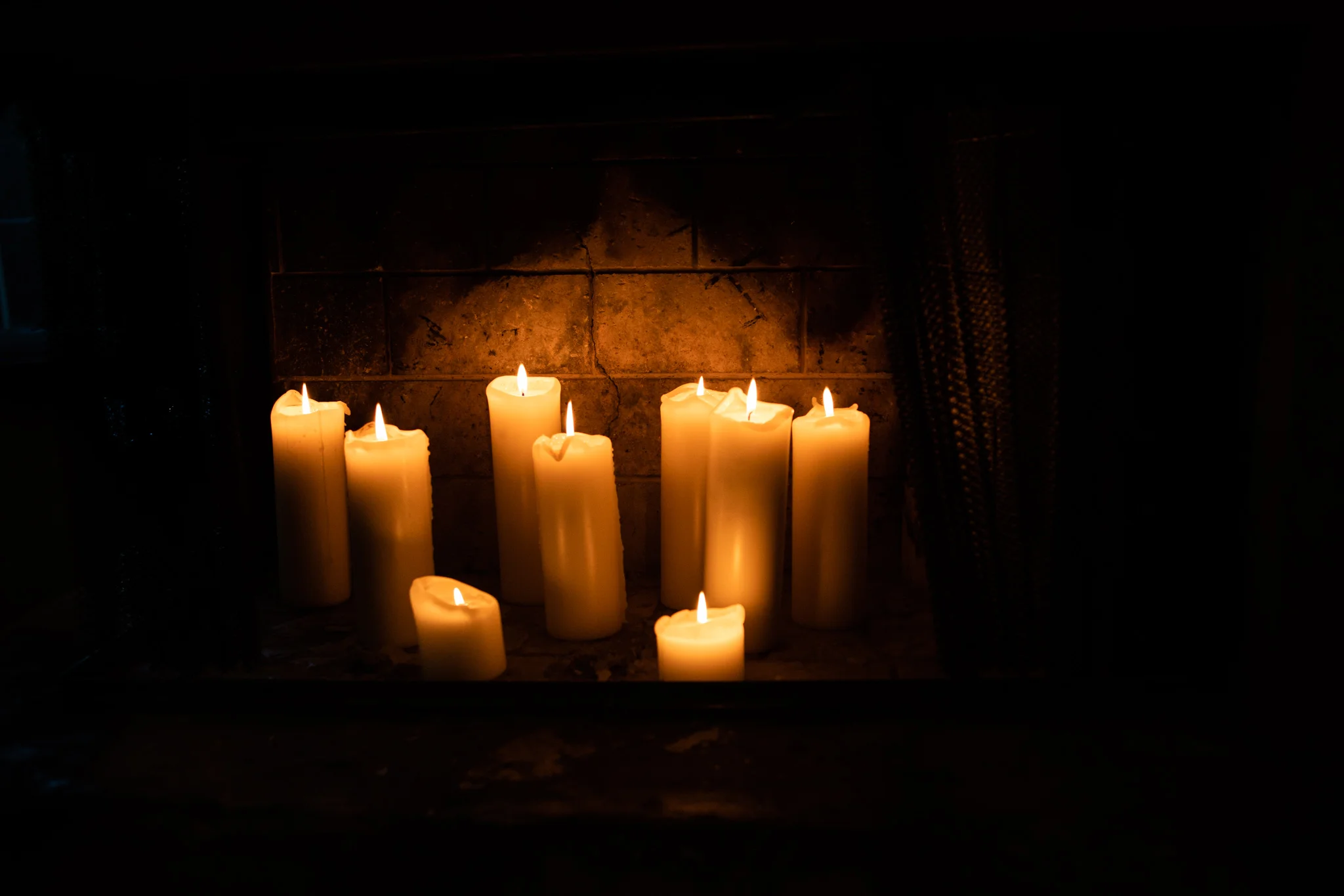several candles lit in fireplace at the auberge du pommier.jpg