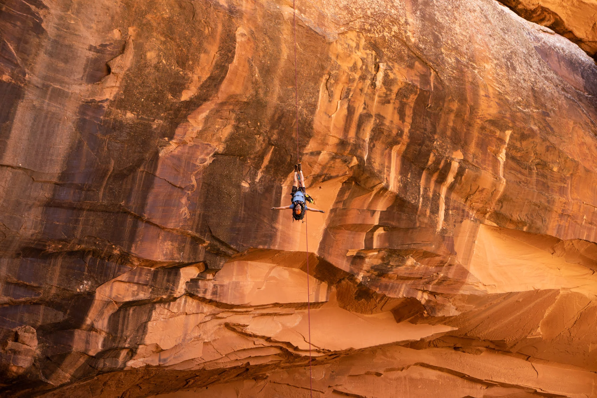rock climber hanging upside down in the Grandstaff Canyon Utah.jpg