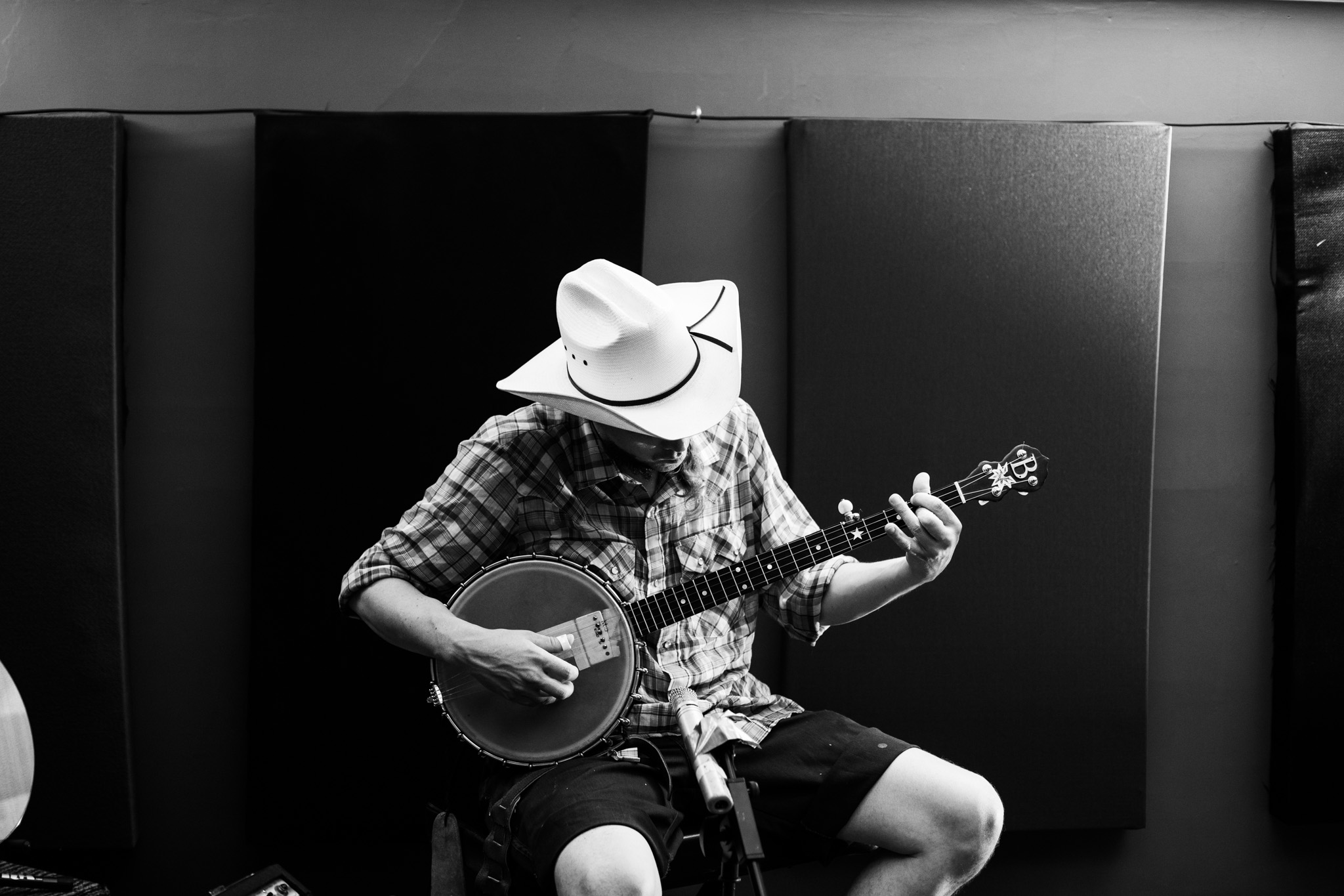 black and white photo of Benj of The Mayhemingways playing banjo in Frederick House Audio.jpg