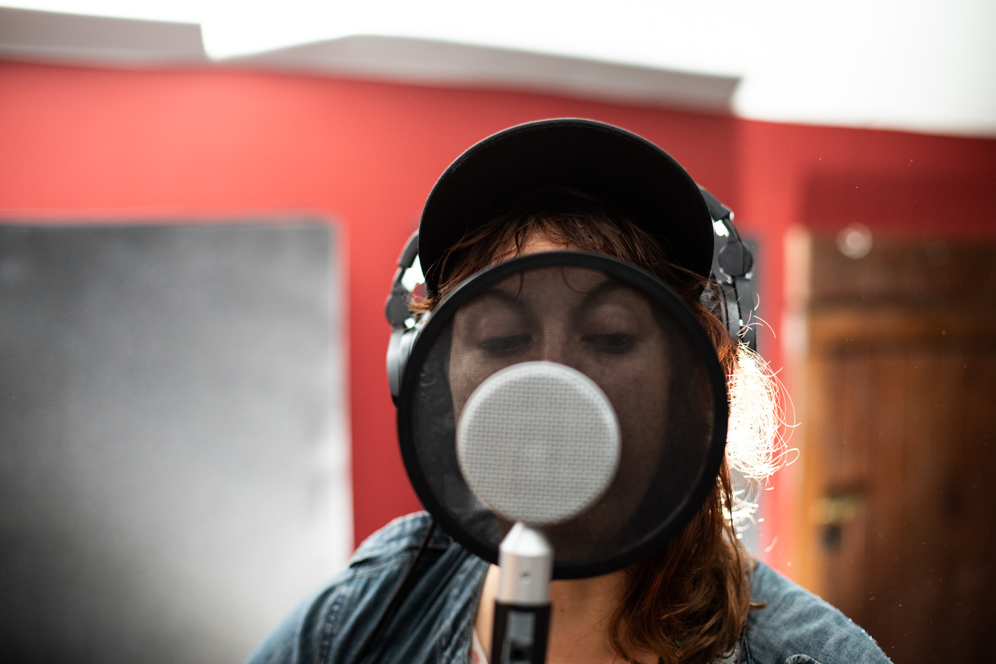 close up of musician singing into recording microphone at Frederick House Audio.jpg