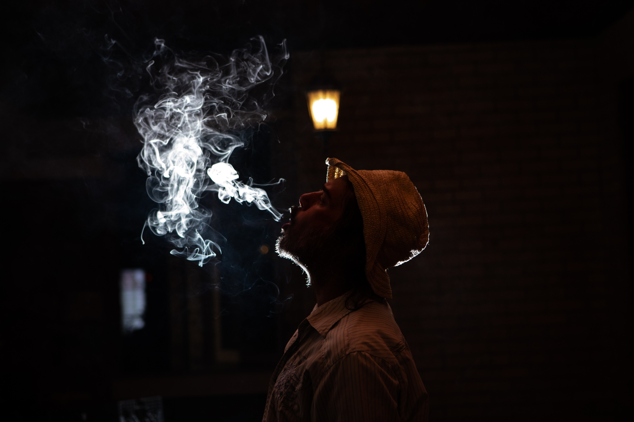 person backlit while blowing smoke.jpg