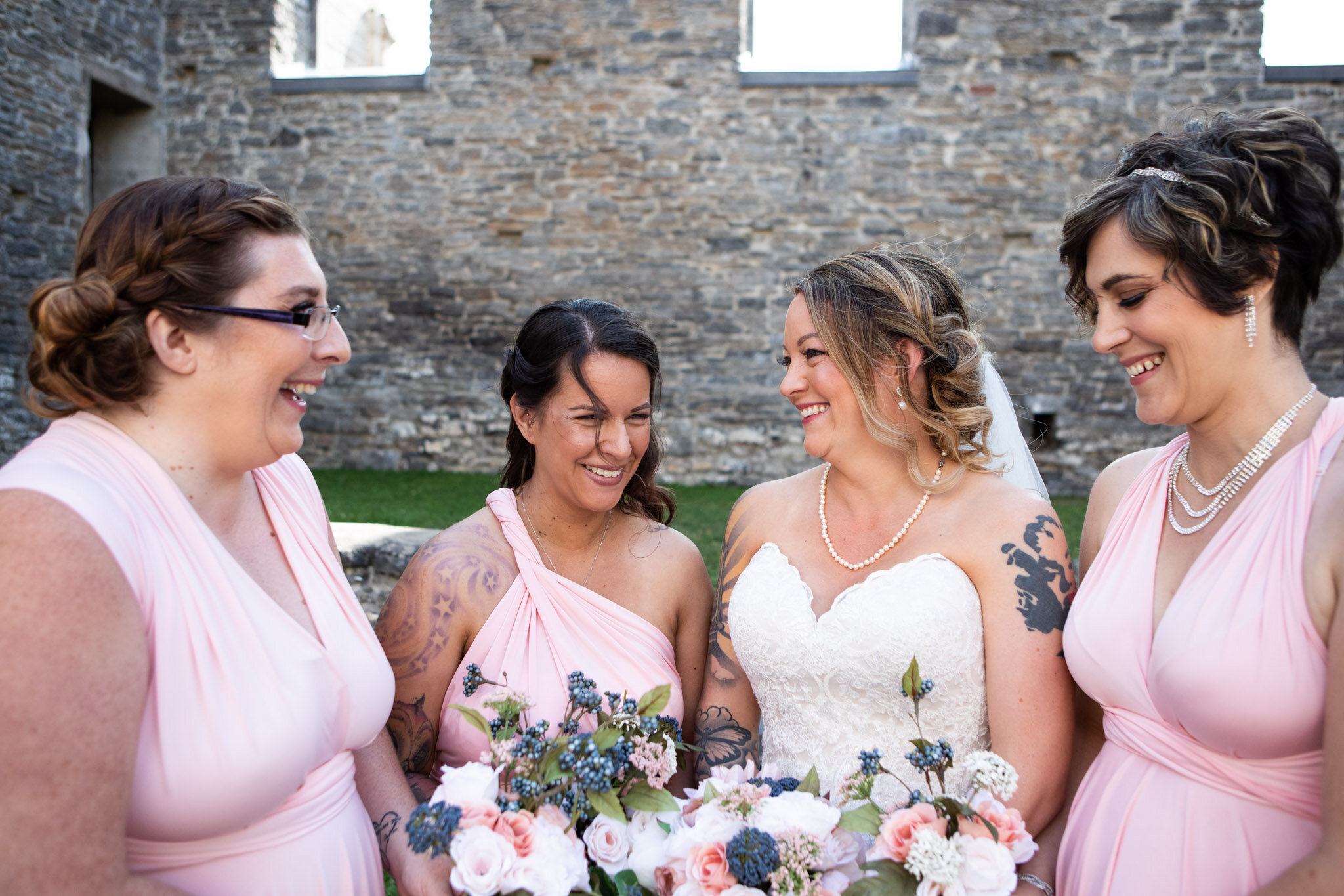 bride and bridemsaids laughing in St Raphael's Ruins.jpg
