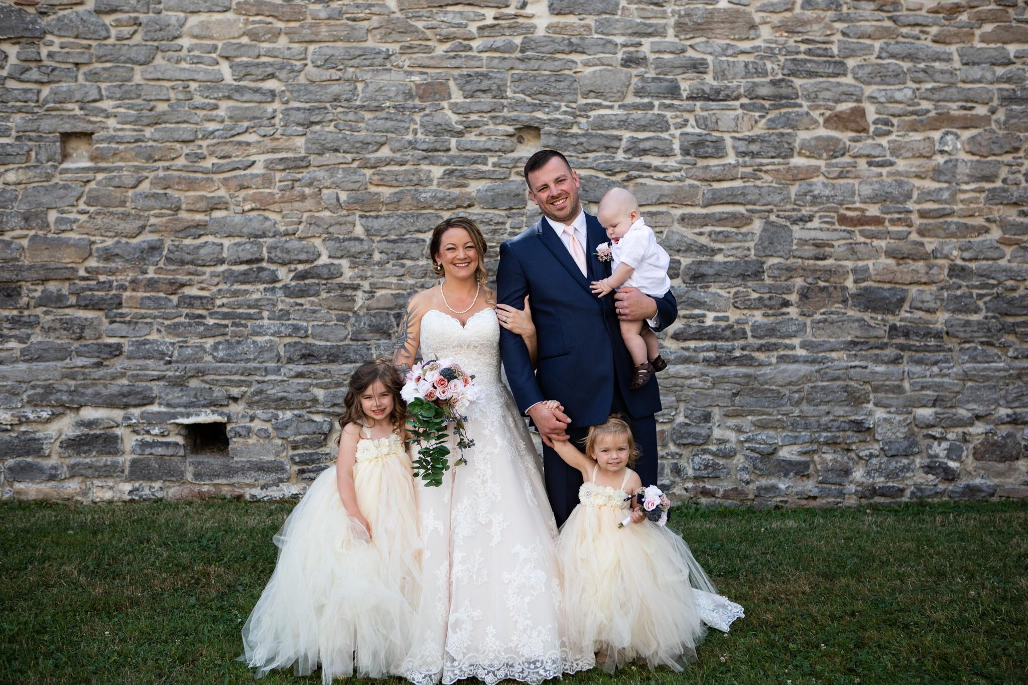 bride and groom family portrait with their children in St Raphael's Ruins.jpg
