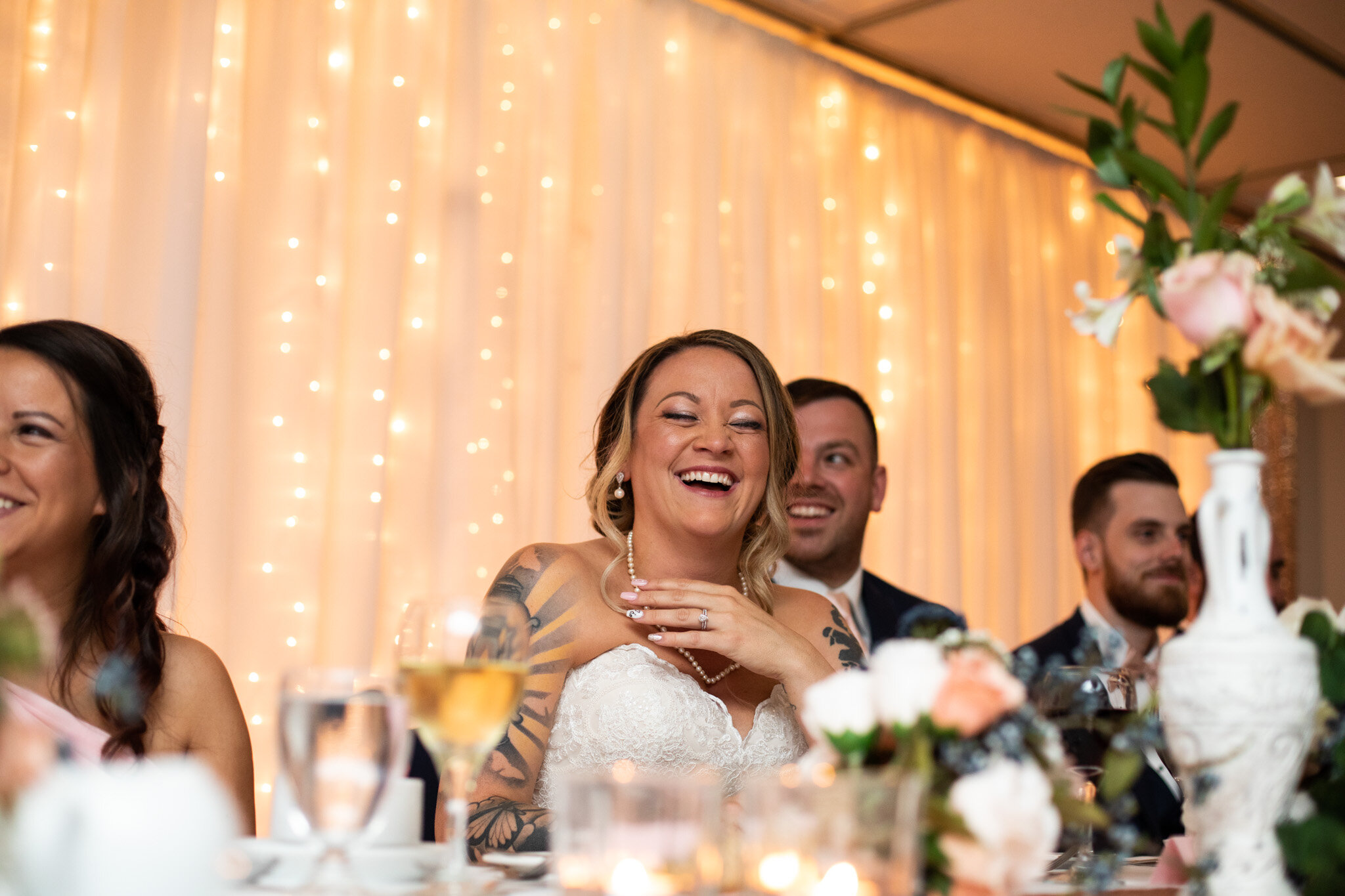 bride laughing during a speech.jpg