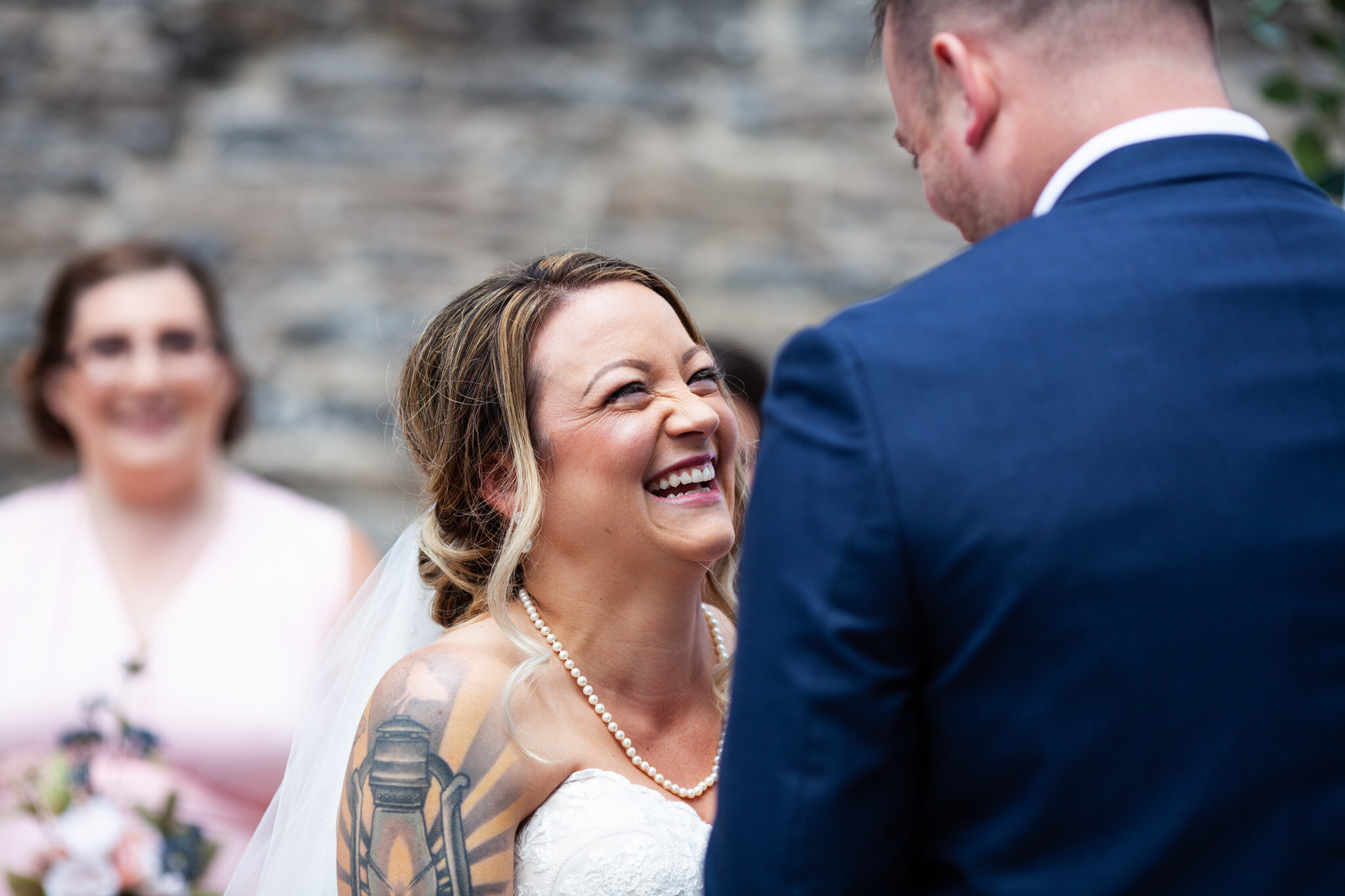 bride laughing during wedding vows in St Raphael's Ruins.jpg