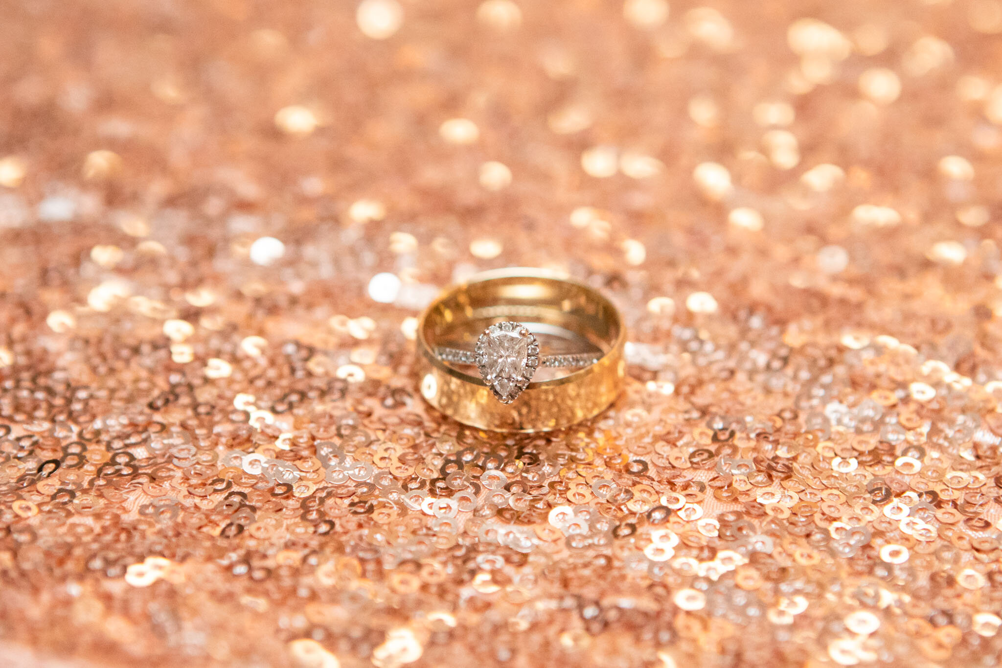 close up of wedding rings on rose gold glitter.jpg