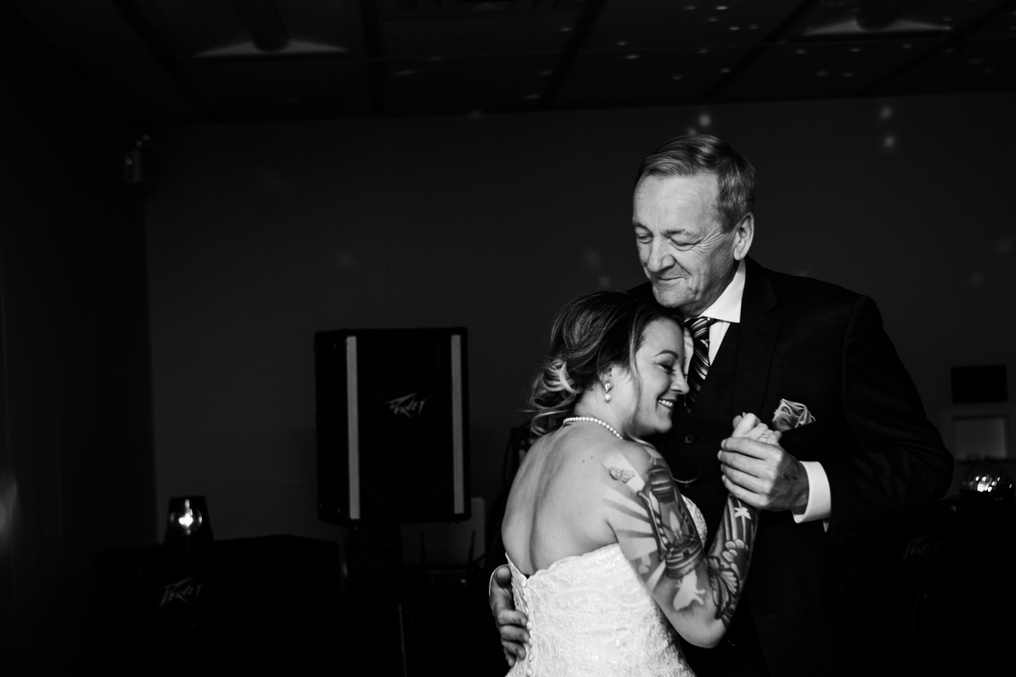 father and daughter dance during wedding reception in NAV Canada Centre in black and white.jpg