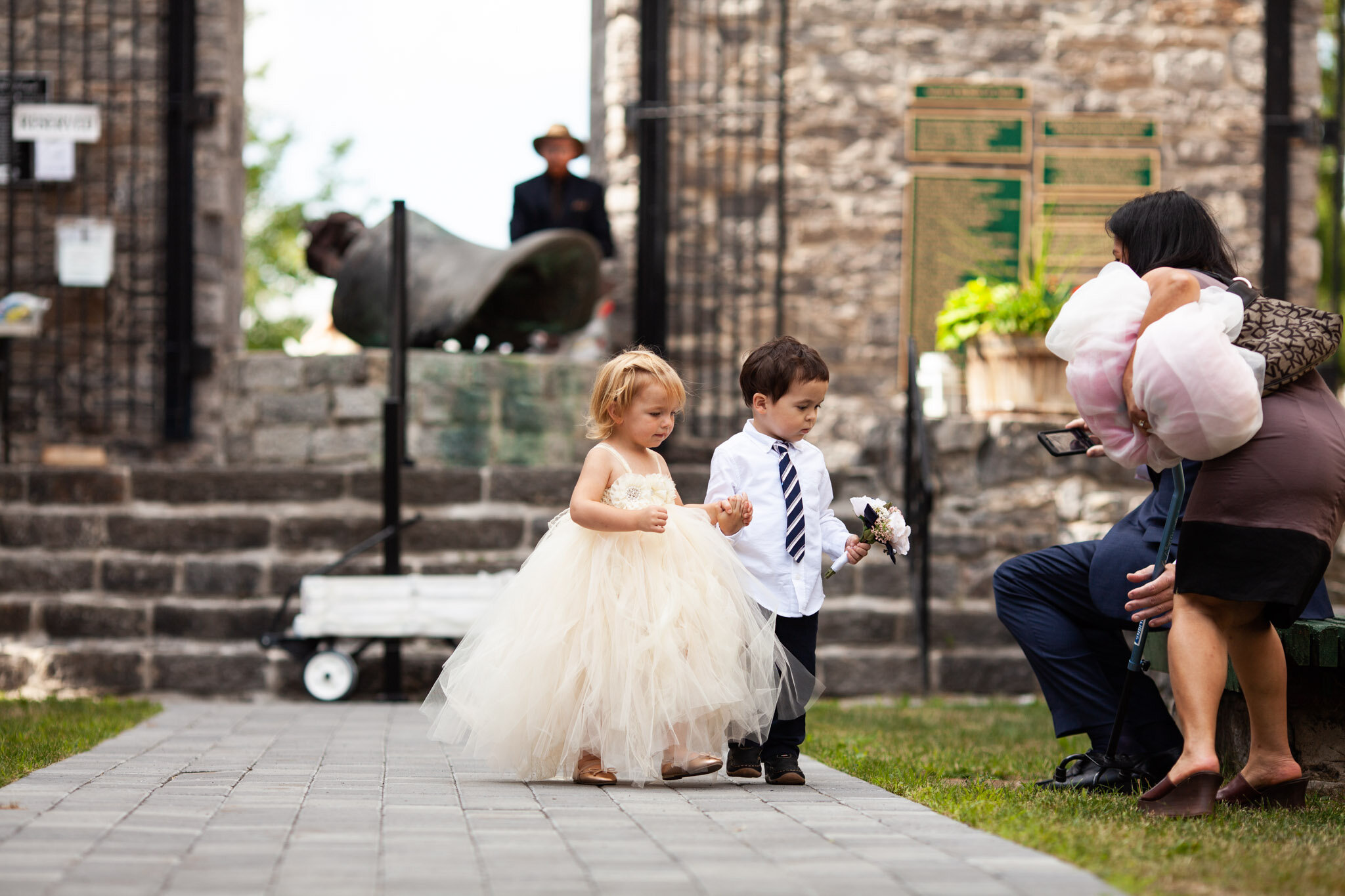 flower girl and ring bearer walking down the aisle at St Raphael's Ruins.jpg