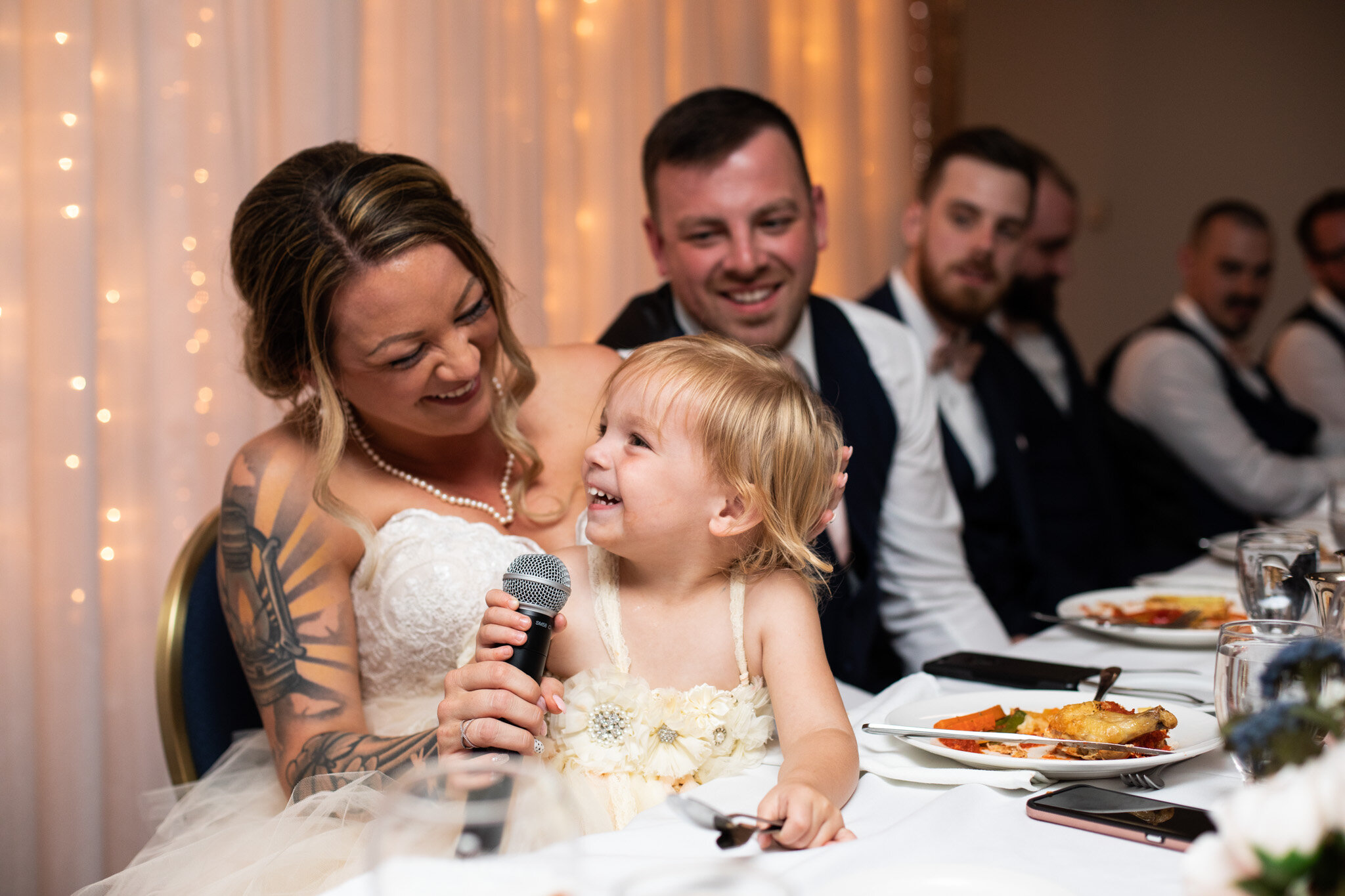 flower girl tries to give a speech with the bride helping at NAV Canada centre.jpg