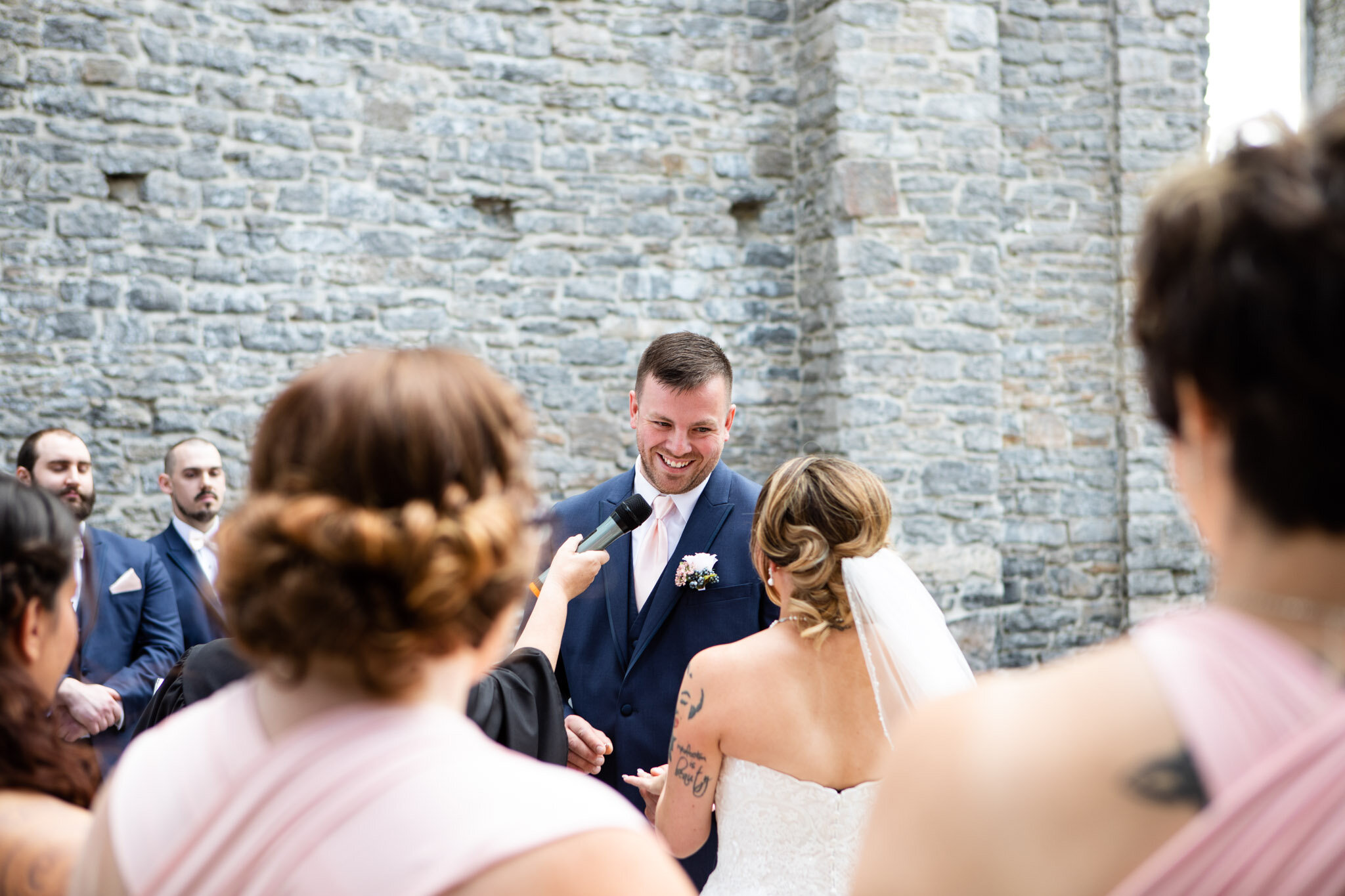 happy groom giving wedding vows in St Raphael's ruins.jpg