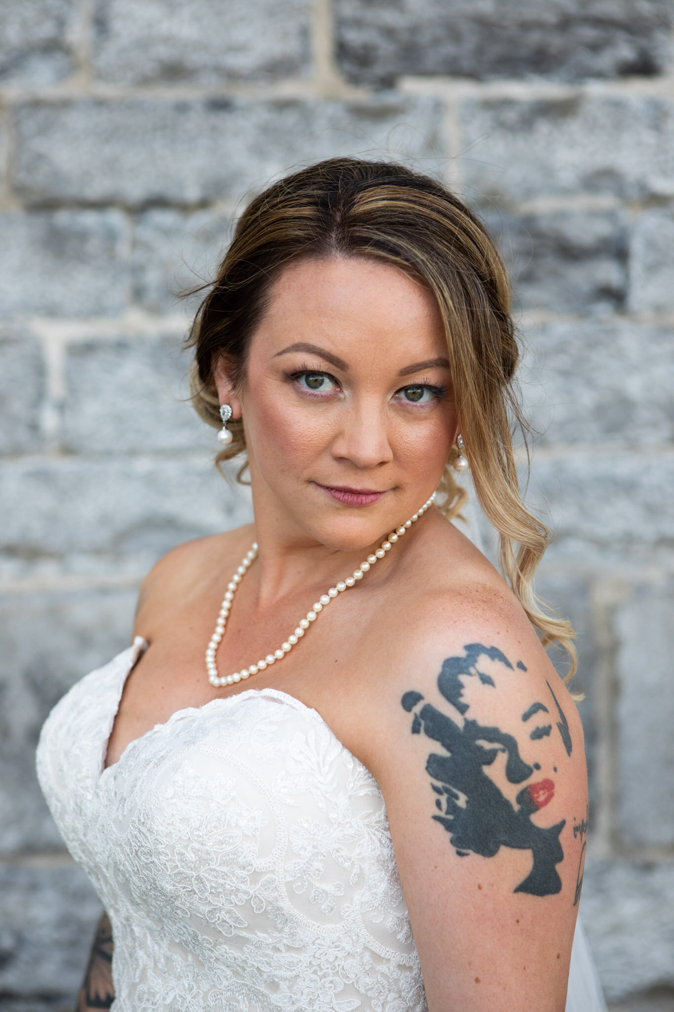 tattooed bridal portrait with pearls with stone wall of St Raphael's ruins in the background.jpg