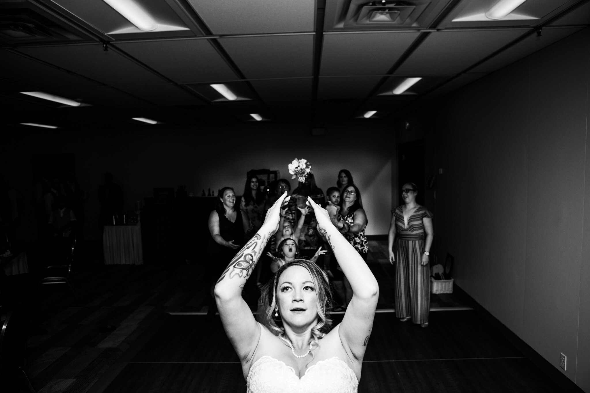 wedding bouquest toss in black and white at NAV Canada Centre.jpg