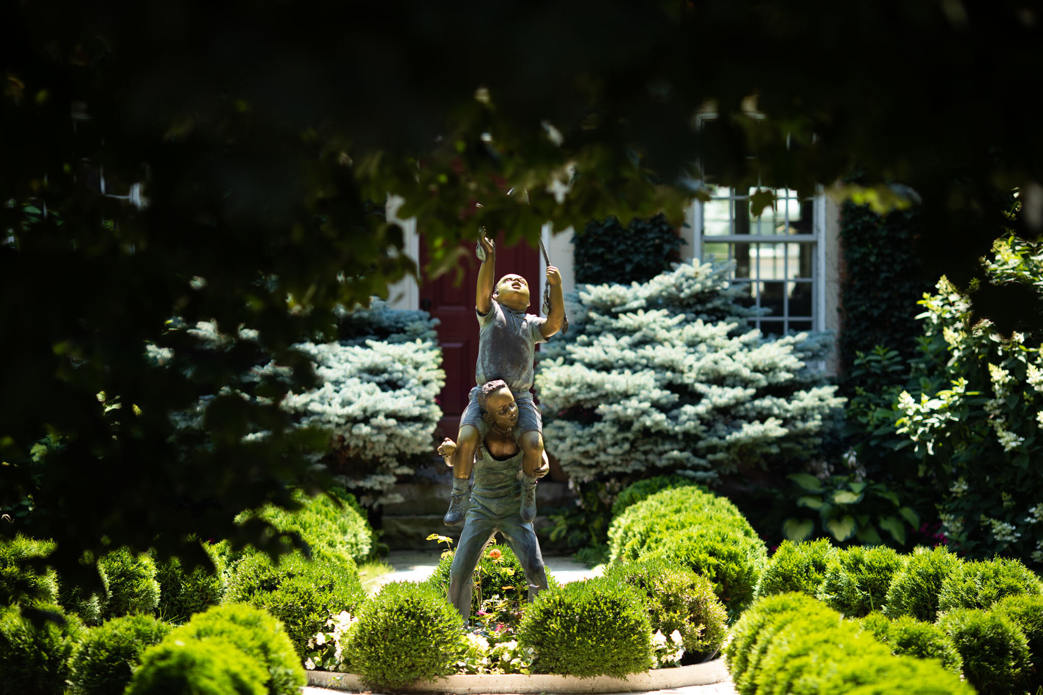 statue of two children playing in a garden at Cherry Avenue Farms Ontario.jpg