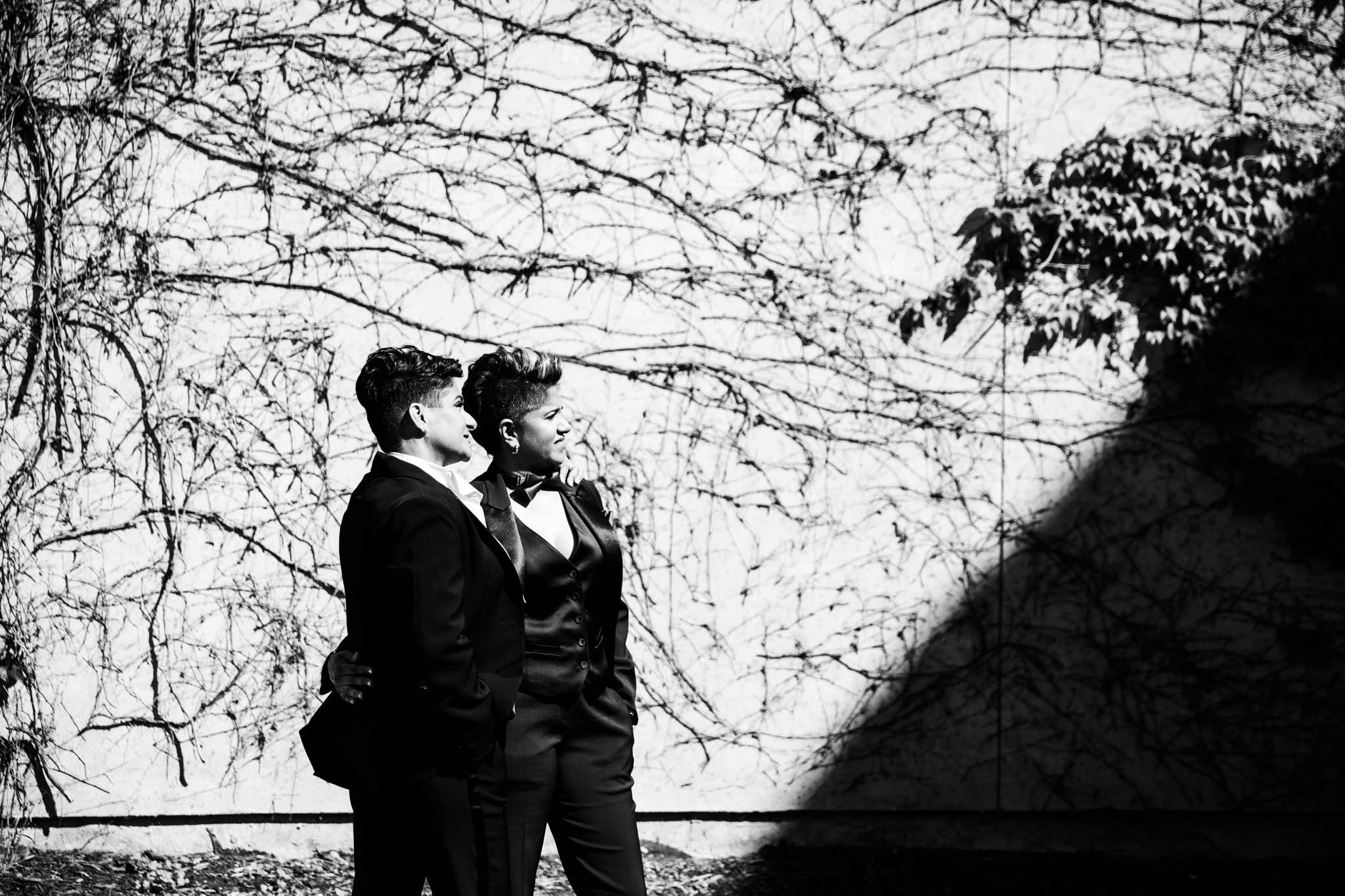 creative black and white photo of brides in full sun and a harsh shadow framing them.jpg