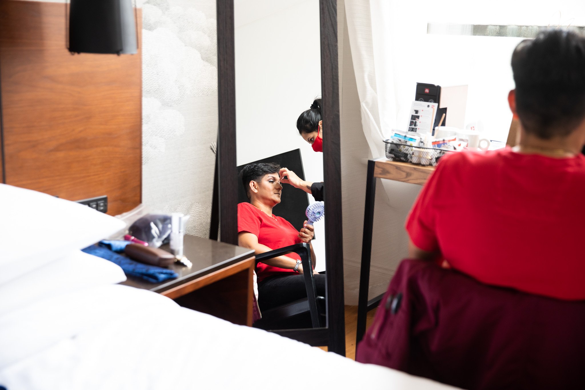 women getting makeup done image reflected in a mirror.jpg