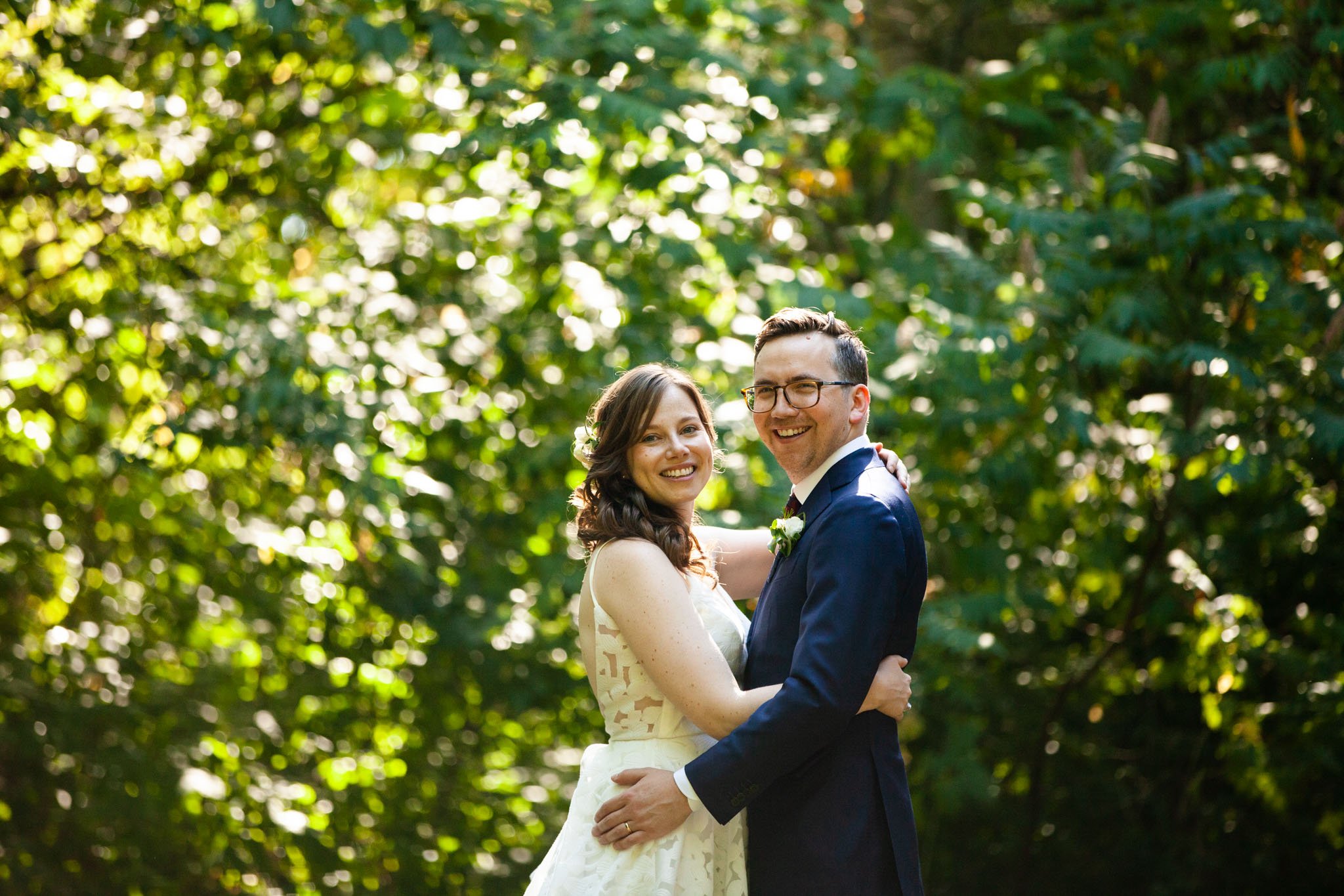 bride and groom couple portrait with green leaves in the background.jpg