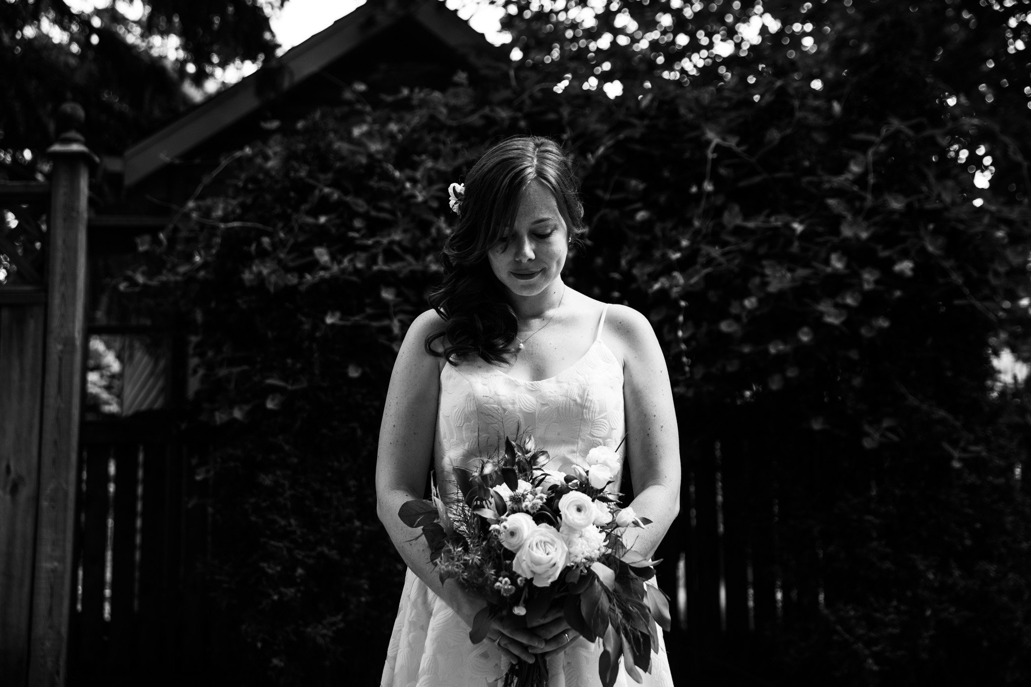 bride looking down at flowers - black and white wedding photography.jpg