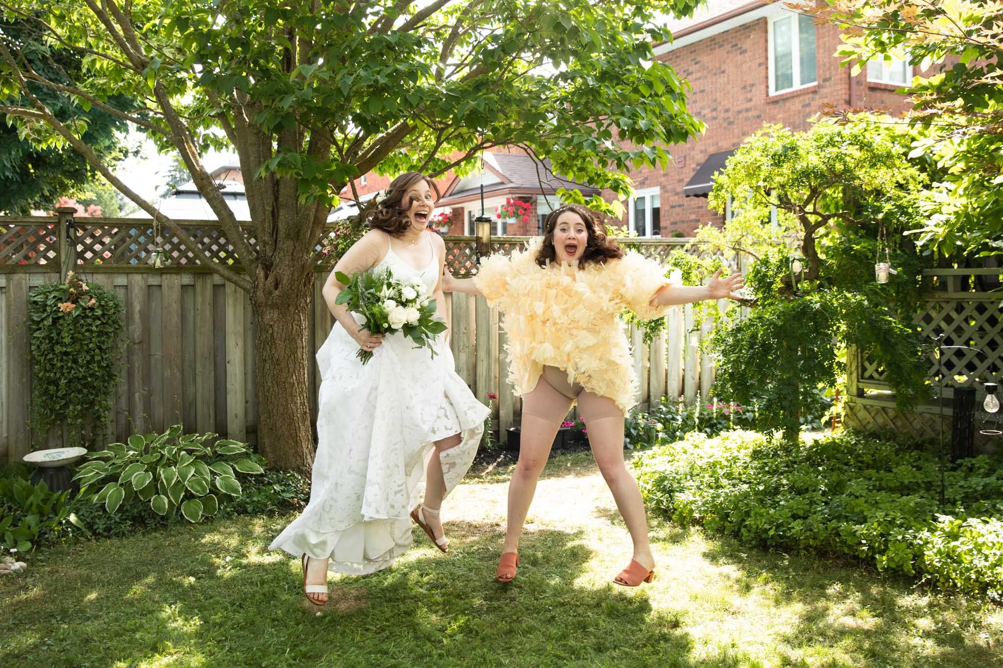 bride and sister jumping and having fun.jpg