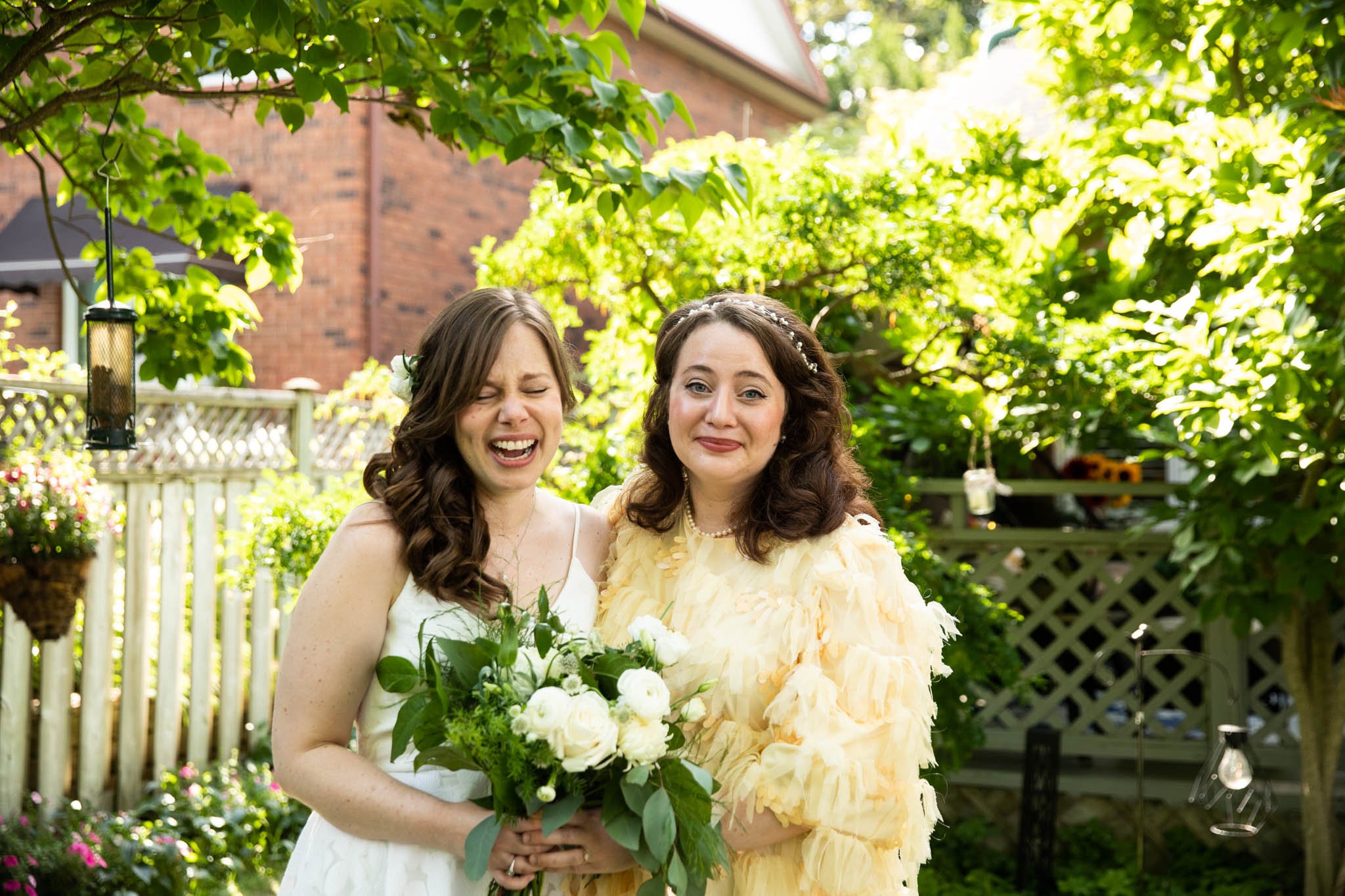 bride and sister laughing outside during portraits.jpg