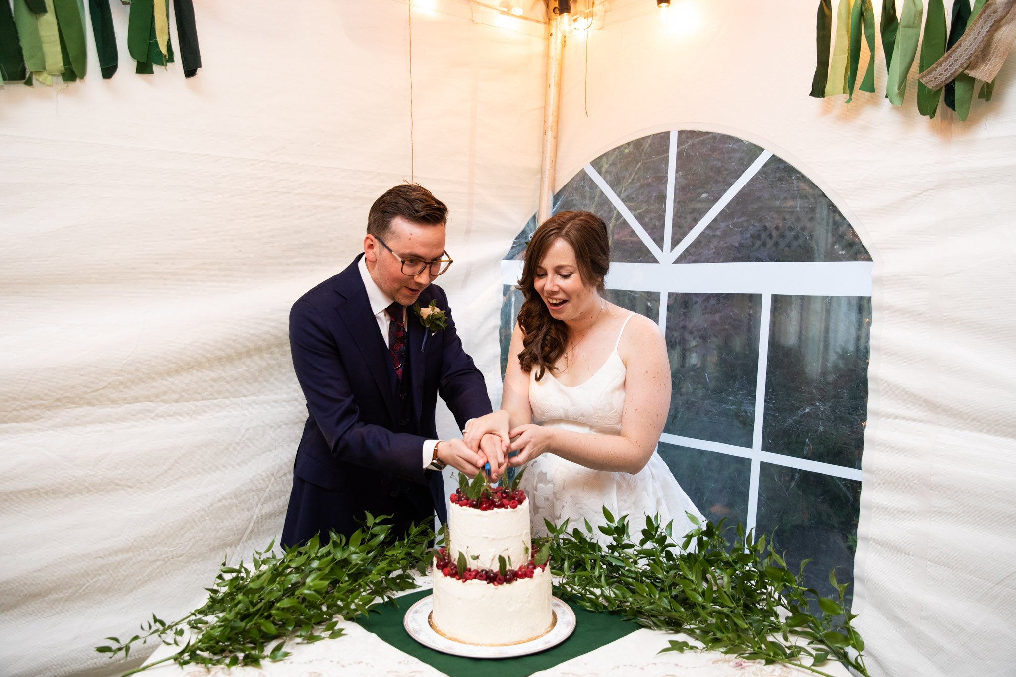 cake cutting with couple behind the cake.jpg